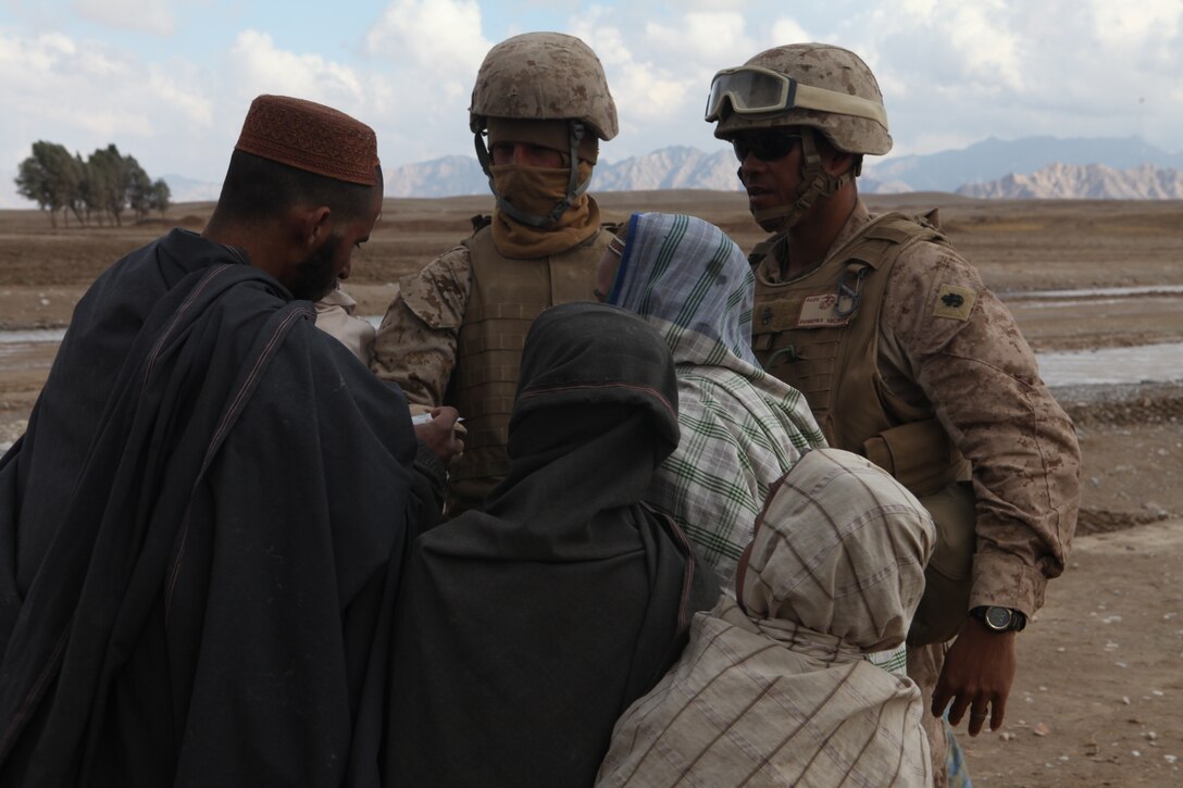 U.S. Navy Chief Hospital Corpsman Paris Dunomes, an independent corpsman attached to Company L, Battalion Landing Team 3/8, 26th Marine Expeditionary Unit, Regimental Combat Team 8, speaks about medical care to a local national  during a patrol to provide assistance in Amanollah Kariz, Helmand province, Afghanistan, Feb. 13, 2011. Elements of the 26th Marine Expeditionary Unit deployed to Afghanistan to provide regional security in Helmand province in support of the International Security Assistance Force.