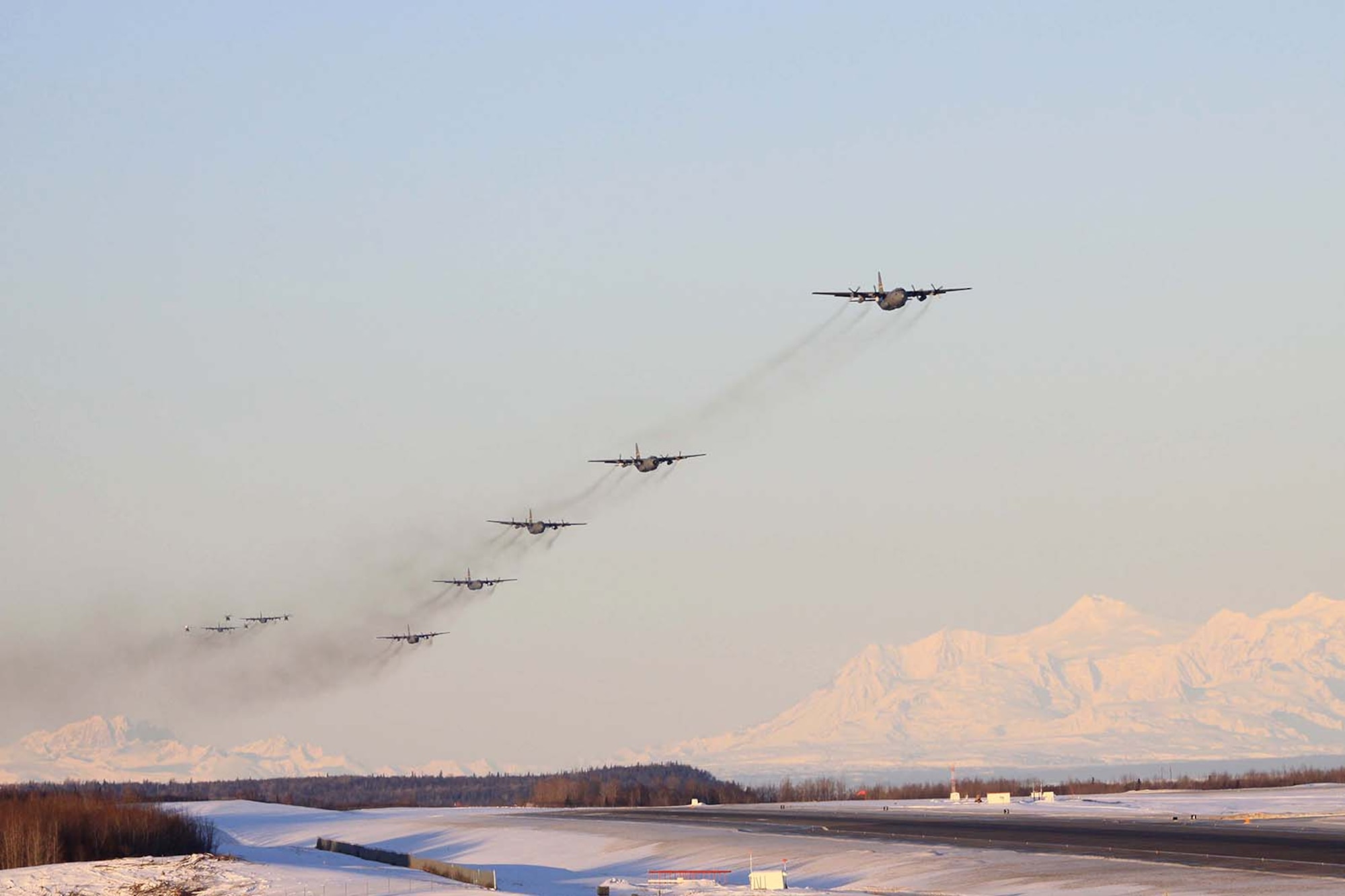 KULIS AIR NATIONAL GUARD BASE, Alaska - Aircraft from the 176th Wing fly over the base in an aerial review, Feb. 12, 2011. Aircraft from the Wing were flown from Kulis to Joint Base Elmendorf-Richardson during a ceremonial flight. The Wing is relocating from Kulis to JBER per the 2005 Defense Base Closure and Realignment proposal.  Alaska Air National Guard photo by Master Sgt. (Ret.) Michael Phillips.