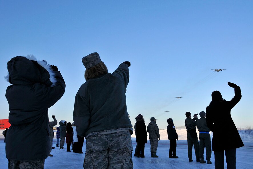 KULIS AIR NATIONAL GUARD BASE, Alaska - Members of the 176th Wing watch as Wing?s aircraft fly over the base, Feb. 12, 2011. Eleven aircraft from the Wing were flown from Kulis to Joint Base Elmendorf-Richardson during a ceremonial flight. The Wing is relocating from Kulis to JBER per the 2005 Defense Base Closure and Realignment proposal.  Alaska Air National Guard photo by Staff Sgt. N. Alicia Goldberger.