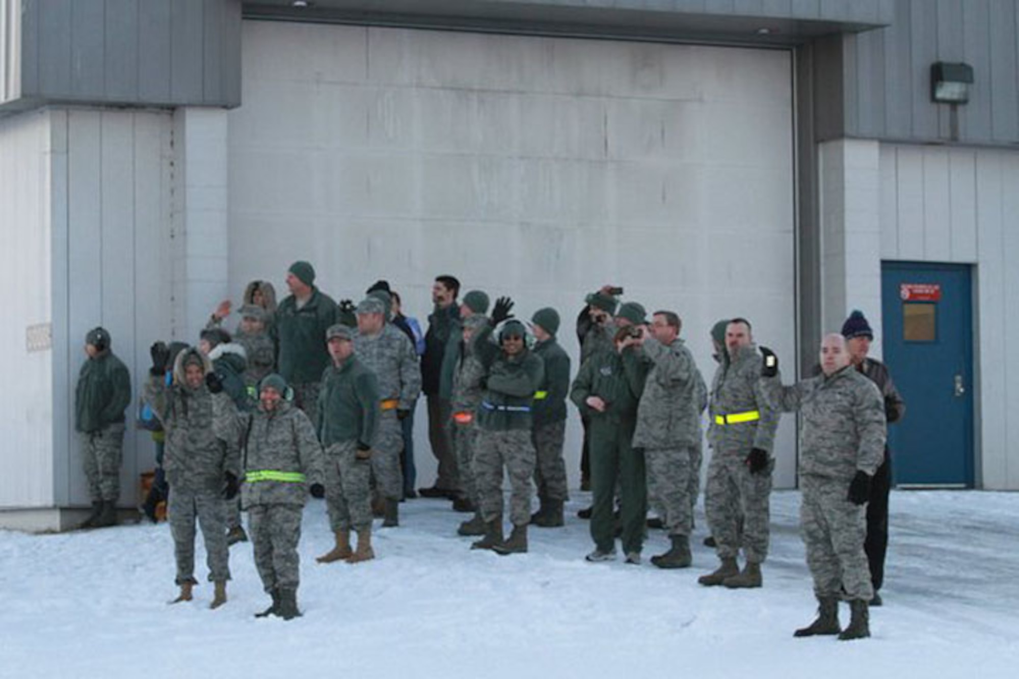 KULIS AIR NATIONAL GUARD BASE, Alaska ? Members of the 176th Wing wave good-bye as Wing?s aircraft roll onto the runway of the Ted Stevens Anchorage International Airport, Feb. 12, 2011. Eleven aircraft from the Wing were flown from Kulis to Joint Base Elmendorf-Richardson during a ceremonial flight. The Wing is relocating from Kulis to JBER per the 2005 Defense Base Closure and Realignment proposal.  Alaska Air National Guard photo by Tech. Sgt. Julie Arthur