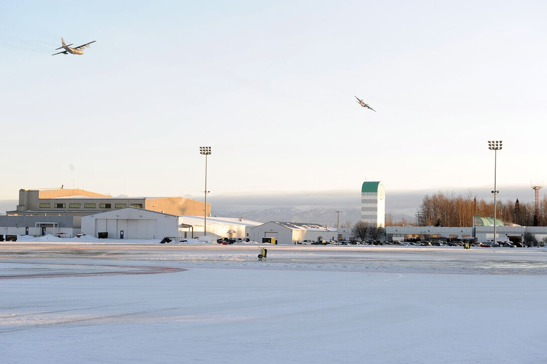 KULIS AIR NATIONAL GUARD BASE, Alaska - Aircraft from the 176th Wing fly over Kulis Air National Guard Base and an empty ramp for the last time, Feb. 12, 2011. Aircraft from the Wing were flown from Kulis to Joint Base Elmendorf-Richardson during a ceremonial flight. The 176th Wing is relocating from Kulis to JBER per the 2005 Defense Base Closure and Realignment proposal.  Alaska Air National Guard photo by Master Sgt. Shannon Oleson.

