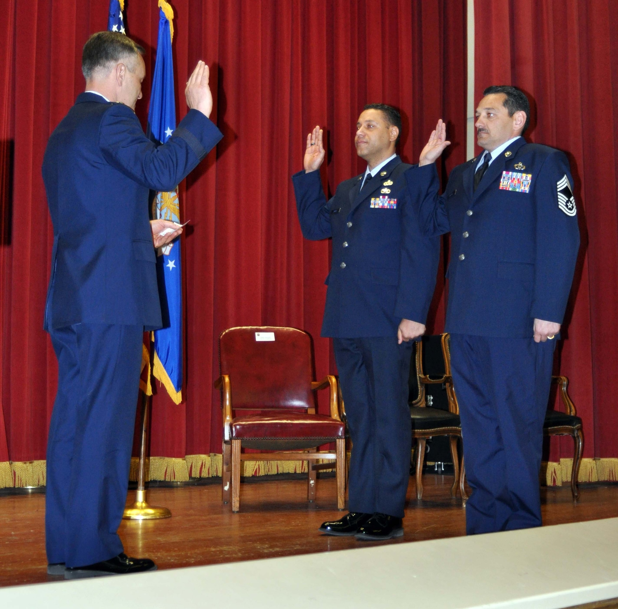 Maj. Gen. Eric W. Crabtree, commander of Fourth Air Force, administers the oath of enlistment to Chief Master Sgt. Mark D. James and Chief Master Sgt. Christopher N. Greene following their promotion ceremony February 13, 2011.  (U.S. Air Force photo/Master Sgt. Linda Welz)