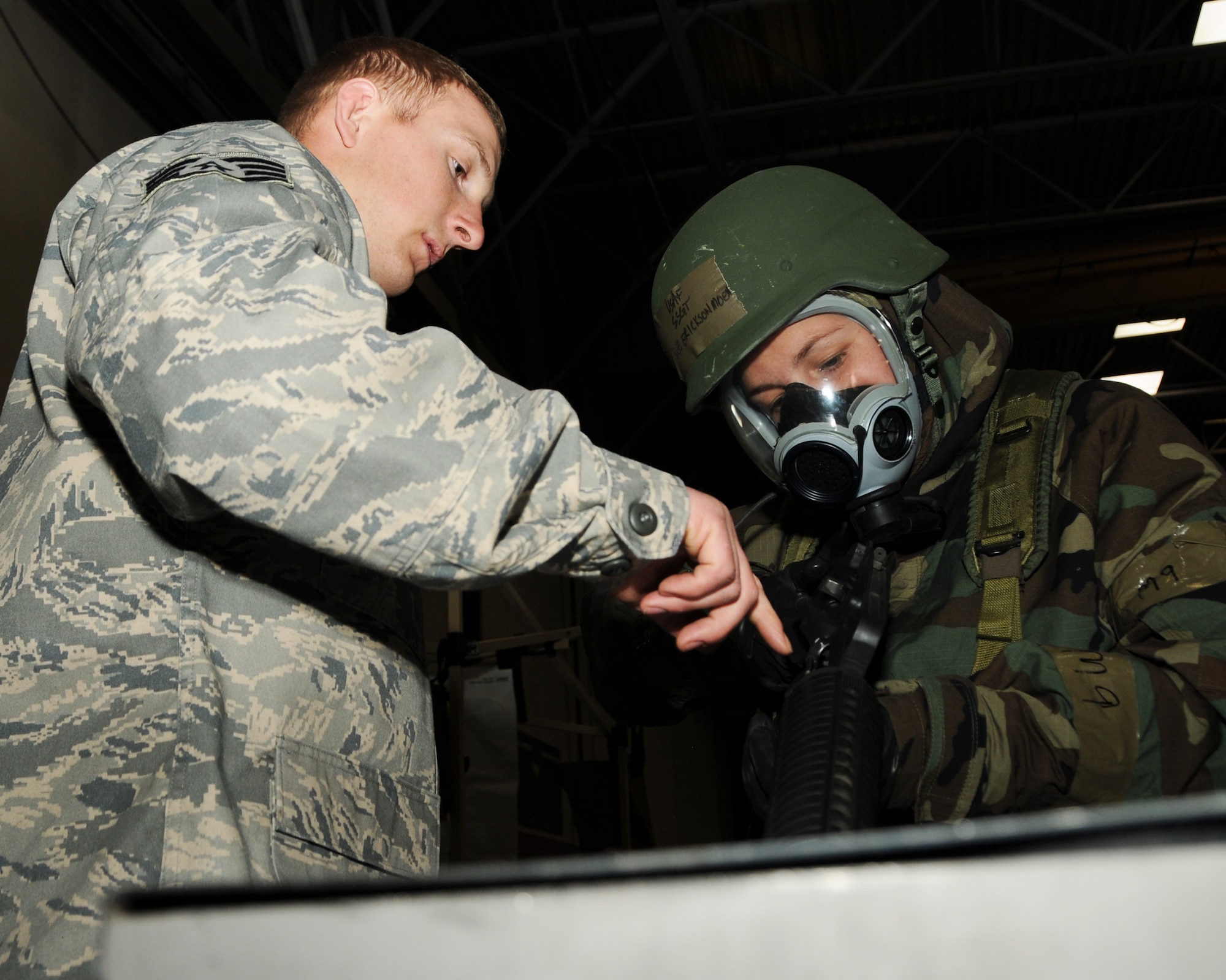 Staff Sgt. Anthony Nickell, 944th Security Forces Squadron, points down the
chamber of an M-16 A2 rifle to show Staff Sgt. Dee Erickson-Moen, 944th
Aeromedical Staging Squadron, that the weapon is clear during a hands-on
Readiness Training Exercise Feb. 13, 2011. (U.S. Air Force photo/Staff Sgt.
Louis Vega Jr.)
