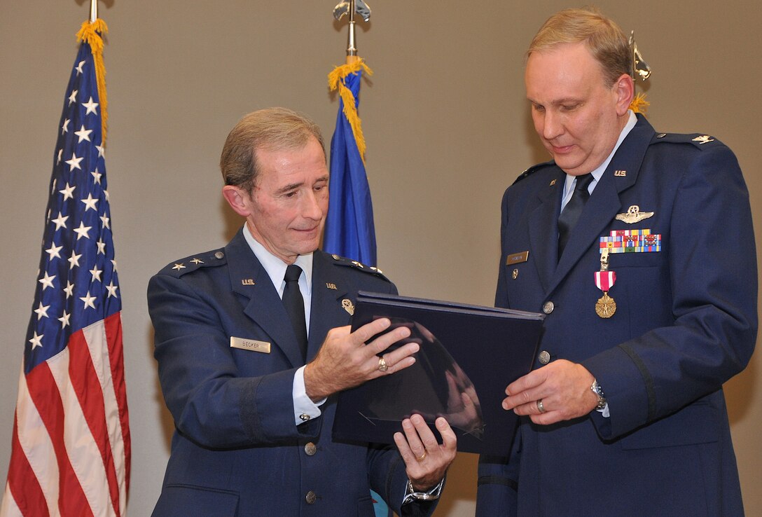 Retired Maj. General John D. Becker presents Col. Jeffery L. Johnson his certificate of retirement Feb. 12, 2011 during a ceremony held in the 932nd Airlift Wing (AW) auditorium at Scott AFB, Ill. Colonel Johnson retired from the Air Force Reserve after nearly 31 years of service. He served the last 22 years at the 932nd AW.
(U.S. Air Force Photo/Tech. Sgt. Christopher R. Parr)