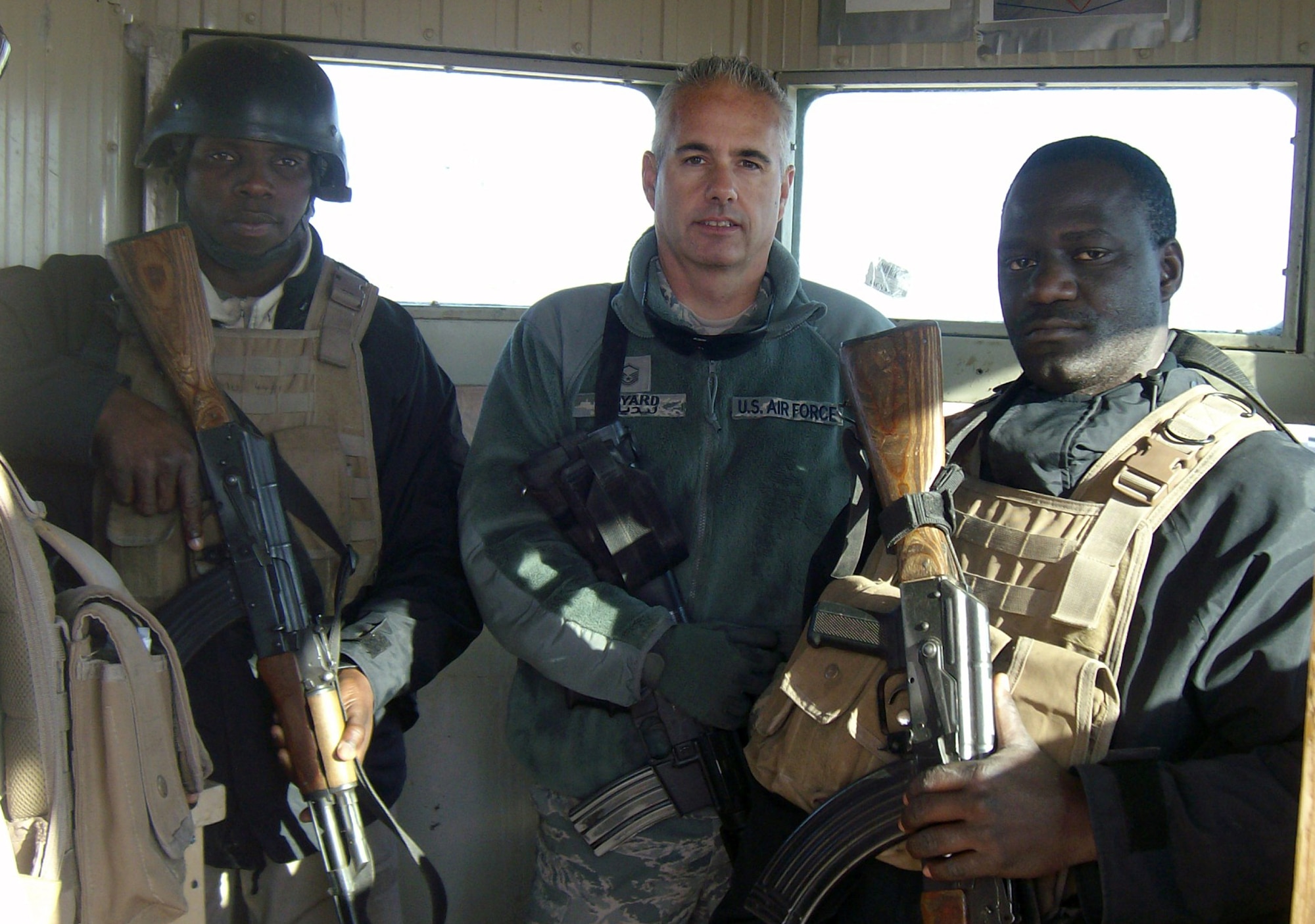 Master Sgt. Brian Lidyard (center) stands with Ugandan troops in a control tower in Iraq, Jan. 21, 2011 during his 120-day deployment. This was Sergeant Lidyard's 10th deployment in his Reserve career. The Puyallup, Wash. resident has been with the 446th Airlift Wing since 1981. (Courtesy photo)