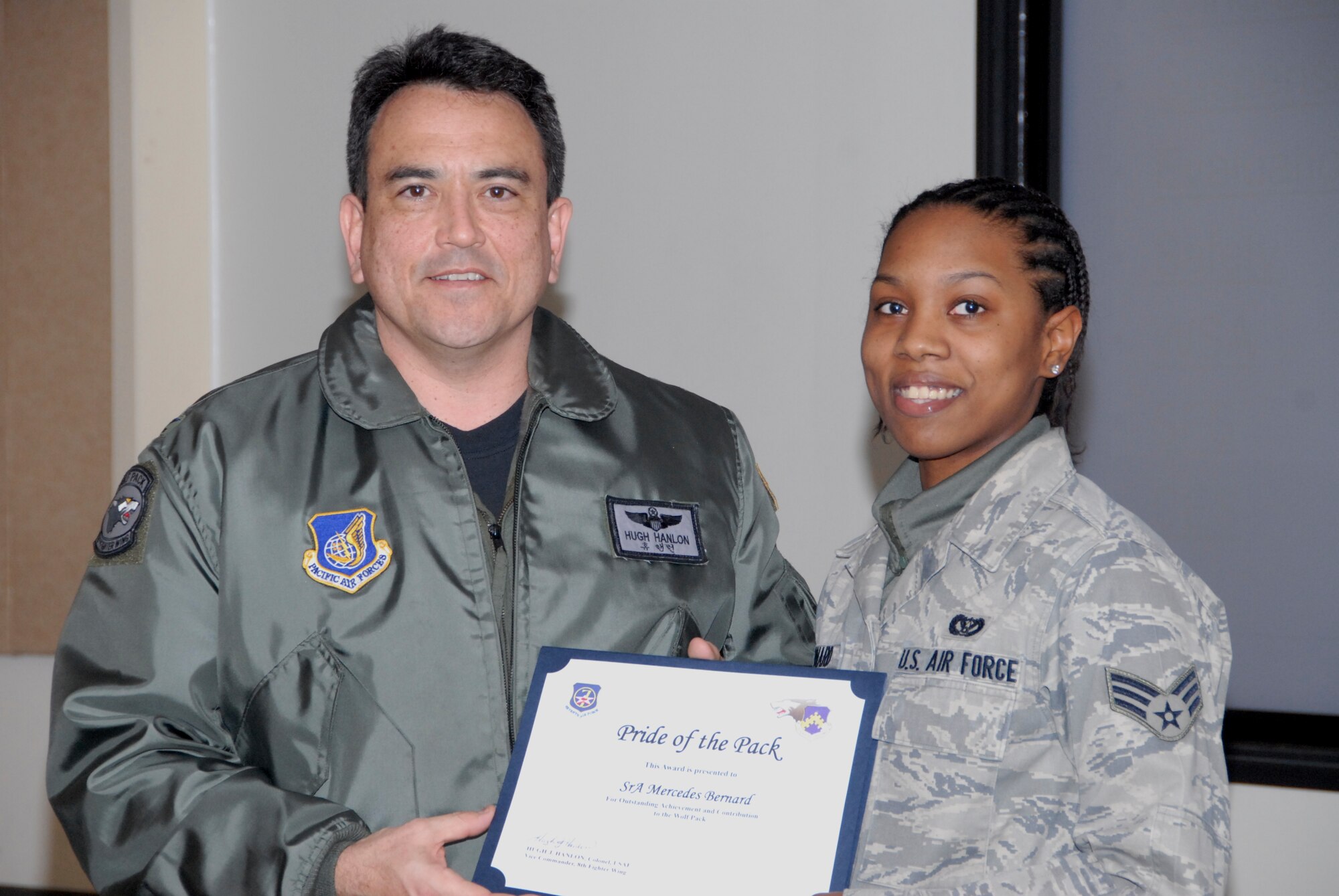 KUNSAN AIR BASE, Republic of Korea -- Col. Hugh Hanlon, 8th Fighter Wing vice commander, presents Senior Airman Mercedes Bernard, 8th Civil Engineer Squadron, with a Pride of the Pack award Feb. 3. (U.S. Air Force photo/Capt. Sheryll Klinkel) 