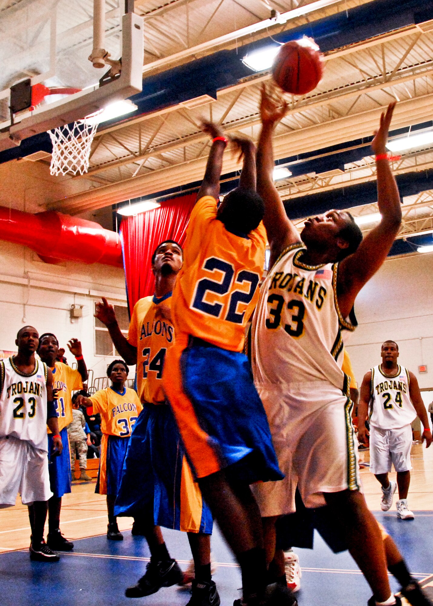 Trojan and Falcon players fight for the rebound at the Northwest Florida Special Olympics basketball championship Feb. 4 at Eglin's Fitness Center. The Trojans beat the Falcons 16-8. (U.S. Air Force Photo/Sachel Seabrook)