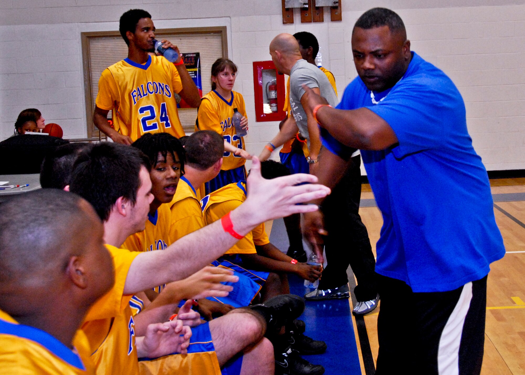 Coach Don Holland high fives his Falcon team during halftime at the Northwest Florida Special Olympics basketball championship Feb. 4 at Eglin's Fitness Center. Trojans beat the Falcons 16-8. (U.S. Air Force Photo/Sachel Seabrook)