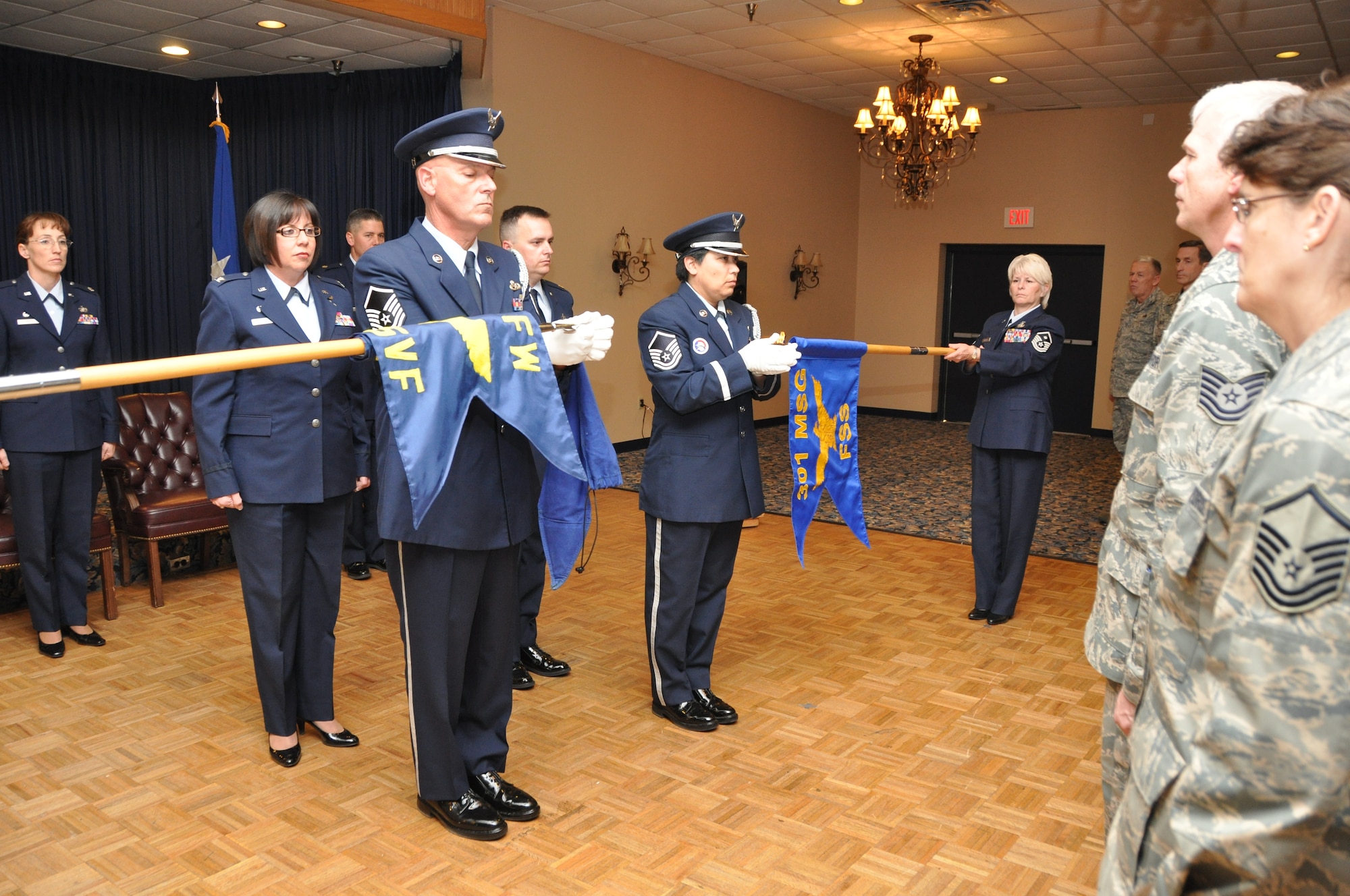 The 301st Force Support Squadron flag is unfurled as the 301st Services Flight flag is furled, signyfing the activation and deactivation of the respective units during an assumption of command ceremony Feb. 12, 2011 at Naval Air Station Fort Worth Joint Reserve Base, Texas. The 301st FSS is comprised of both the 301st MIssion Support Squadron and Services Flight. Lt.Col. Kathryn Smith is the new 301st FSS commander. (U.S. Air Force photo/SrA Melissa Harvey).