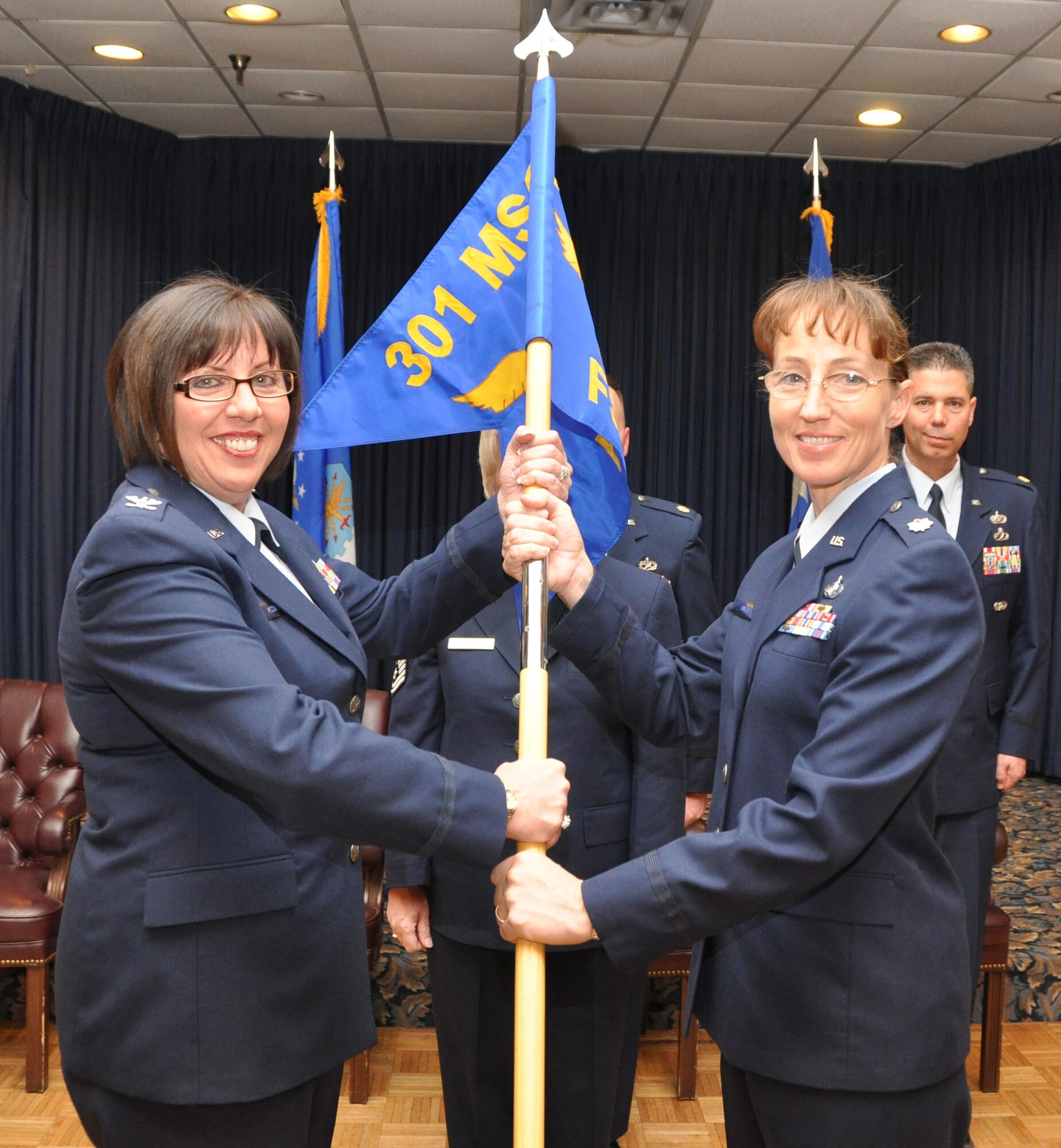 Col. Linda McCourt, 301st Mission Support Group commander, and Lt. Col. Kathryn Smith, 301st Force Support Squadron commander, officially activate the 301st FSS during an assumption of command ceremony Feb. 12, 2011 at Naval Air Station Fort Worth Joint Reserve Base, Texas. The 301st FSS is comprised of both the 301st Mission Support Squadron and Services Flight. (U.S. Air Force photo/SrA Melissa Harvey).