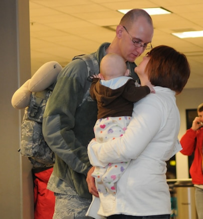 Senior Airman Justin Lemon gets a last kiss from his wife and baby before boarding his flight at the Salt Lake City International airport on February 3, 2011. Airman Lemon is one of the 33 members with the Utah Air National Guard's 151st Security Forces Squadron who left for a six-month deployment to Iraq.(U.S. Air Force photo by Master Sgt. Gary J. Rihn)(RELEASED)