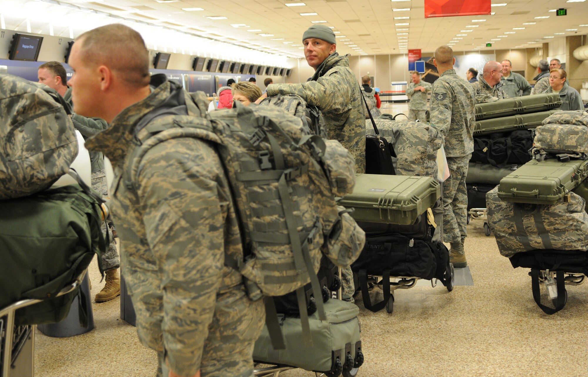 Guardsmen from the Utah Air National Guard's 151st Security Forces Squadron wait in line to check their bags before boarding their flight. The 151st SFS left for a six-month deployment to Iraq, on February 3, 2011, from the Salt Lake City International airport. (U.S. Air Force photo by Master Sgt. Gary J. Rihn)(RELEASED)