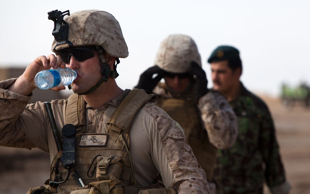 Capt. Alfred Butler, the commanding officer of Weapons Company, 2nd Battalion, 1st Marine Regiment, talks to elders of Belush about flooding damage to the courtyard of a local mosque, Feb. 13. The flooding occurred the night before. Weapons Company's headquarters is Patrol Base Gorgak in Garmsir District.