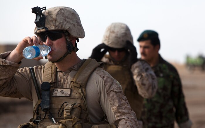 Capt. Alfred Butler, the commanding officer of Weapons Company, 2nd Battalion, 1st Marine Regiment, talks to elders of Belush about flooding damage to the courtyard of a local mosque, Feb. 13. The flooding occurred the night before. Weapons Company's headquarters is Patrol Base Gorgak in Garmsir District.