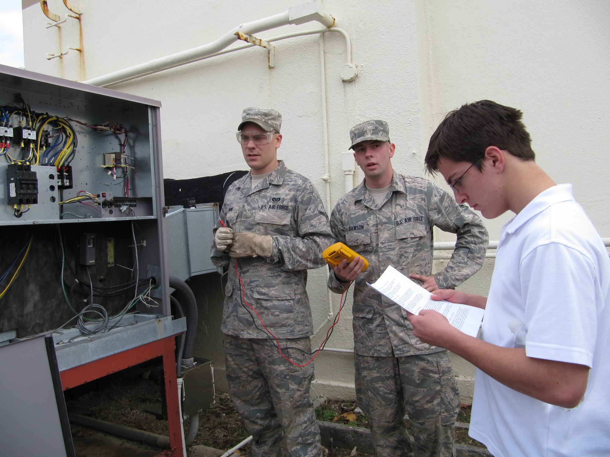 Kadena sophomore Chris Carlson consults his notes and listens attentively during a presentation given by 18th Civil Engineer Squadron Arimen during Kadena High School's Job Shadow Day. (Courtesy photo)