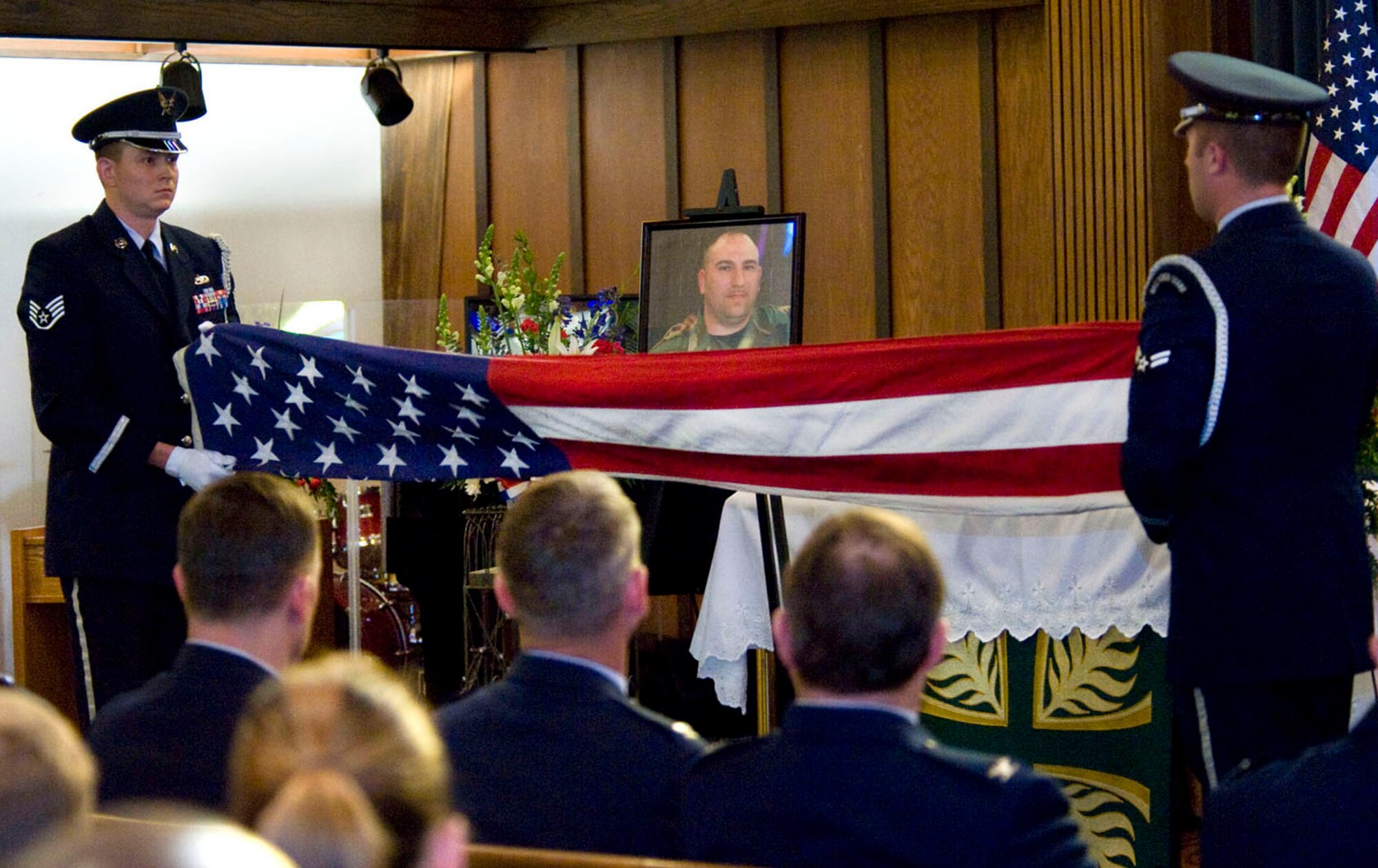 NELLIS AIR FORCE BASE, Nev.-- The Nellis Honor Guard performs a flag-folding ceremony during the memorial service for Tech. Sgt. Robert V. Hetrick Jr. at the base chapel Feb. 10. Sergeant Hetrick, 36, assigned to the 57th Aircraft Maintenance Squadron passed away unexpectedly Feb. 2. He recently relocated to Nellis from Langley AFB, Va. (U.S Air Force photo by Senior Airman Stephanie Rubi)

