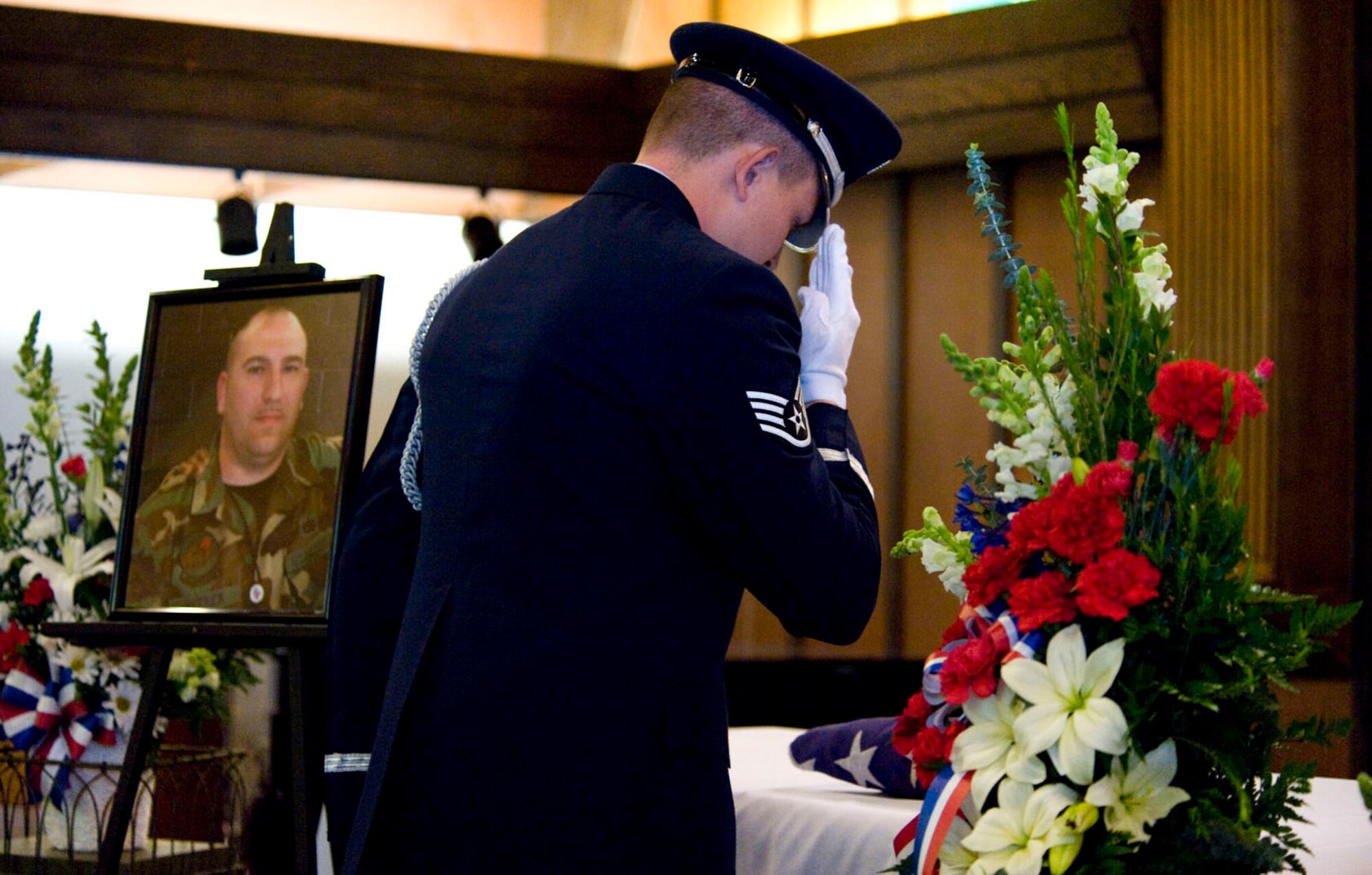 NELLIS AIR FORCE BASE, Nev.-- Staff Sgt. Daren Cantu, 99th Air Base Wing honor guard member, renders a final salute during a memorial service for Tech. Sgt. Robert V. Hetrick Jr. at the base chapel Feb. 10. Sergeant Hetrick, 36, assigned to the 57th Aircraft Maintenance Squadron passed away unexpectedly Feb. 2. He recently relocated to Nellis from Langley AFB, Va. (U.S Air Force photo by Senior Airman Stephanie Rubi)
