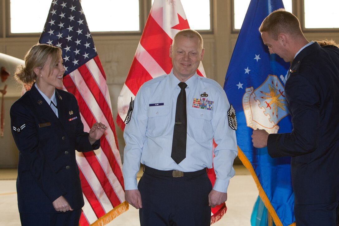 CMSgt Kevin Kling gets pinned by his son 2nd Lieutenant Adam Kling and daughter A1C Jenna Kling during his promotion ceremony. The 113th Maintenance Squadron held its first ever pining of three Chief Master Sergeants during a promotion ceremony on February 12, 2011 at Hanger 18, Andrews Air Force Base (U.S Air Force photo by Tech. Sgt. Gareth Buckland/Released)