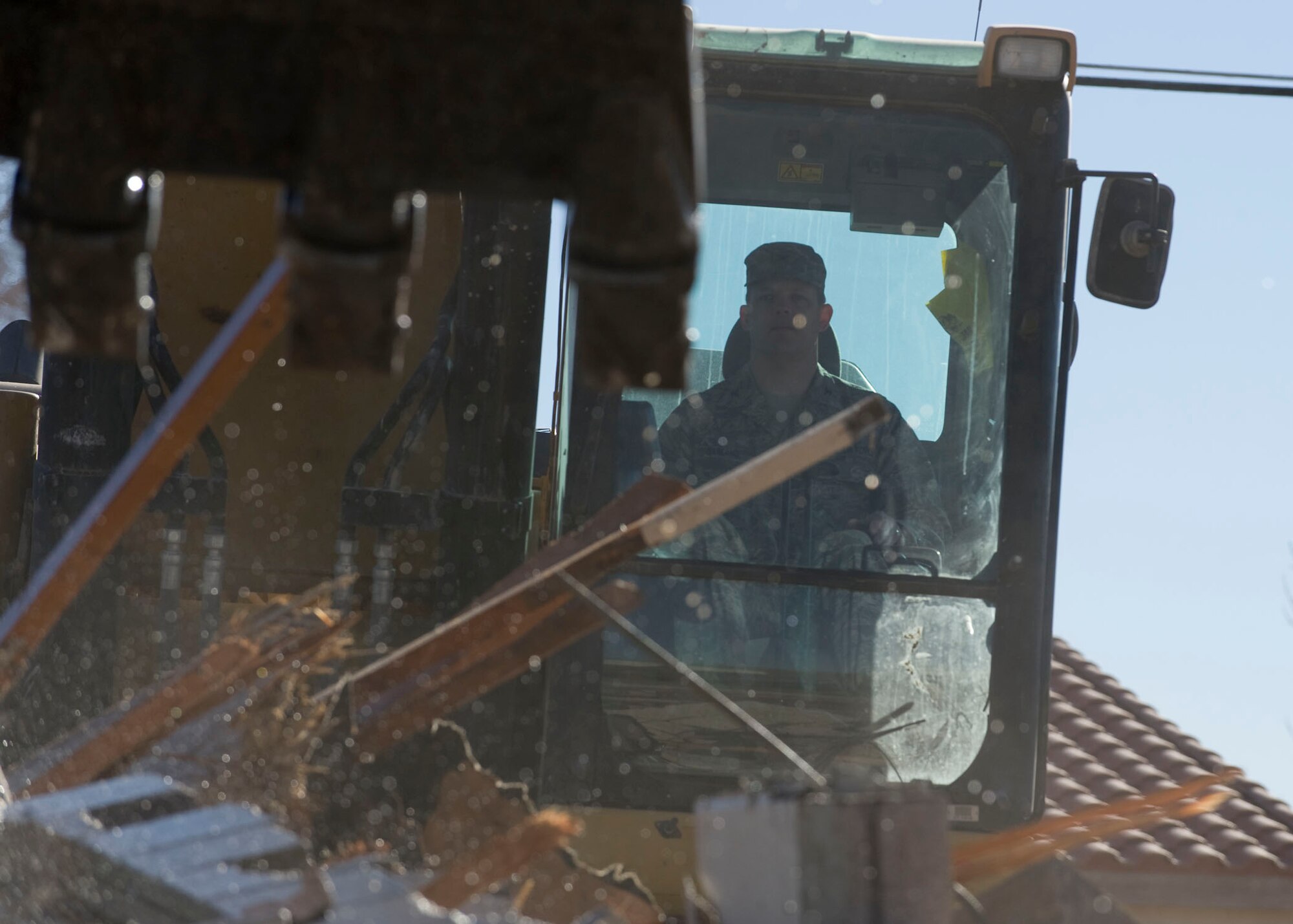 NELLIS AIR FORCE BASE, Nev.-- Col. Steve Garland, 99th Air Base Wing commander, knocks down a wall of a 1950's-era house in the Nellis Landings community Feb. 11. The house on Baer Drive was the last of 315 houses demolished in a project which began in May 2006. (U.S. Air Force photo by Airman 1st Class George Goslin)