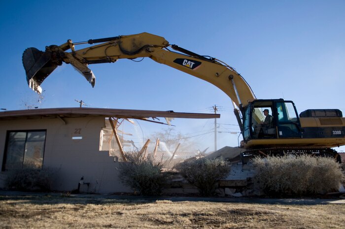 NELLIS AIR FORCE BASE, Nev.-- Col. Steve Garland, 99th Air Base Wing commander, prepares to demolish the roof of a 1950's-era house in the Nellis Landings community Feb. 11. The house on Baer Drive was the last of 315 houses demolished in a project which began in May 2006. (U.S. Air Force photo by Airman 1st Class George Goslin)