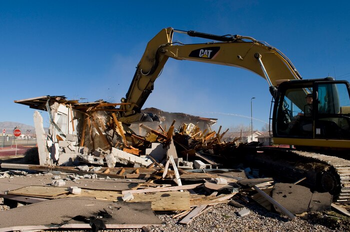 NELLIS AIR FORCE BASE, Nev. -- Col. Steven Garland, 99th Air Base Wing commander, demolishes a 1950's-era house in the Nellis Landings community Feb. 11. The house on Baer Drive was the last of 315 houses demolished in a project which began in May 2006. (U.S. Air Force photo by Airman 1st Class George Goslin)
