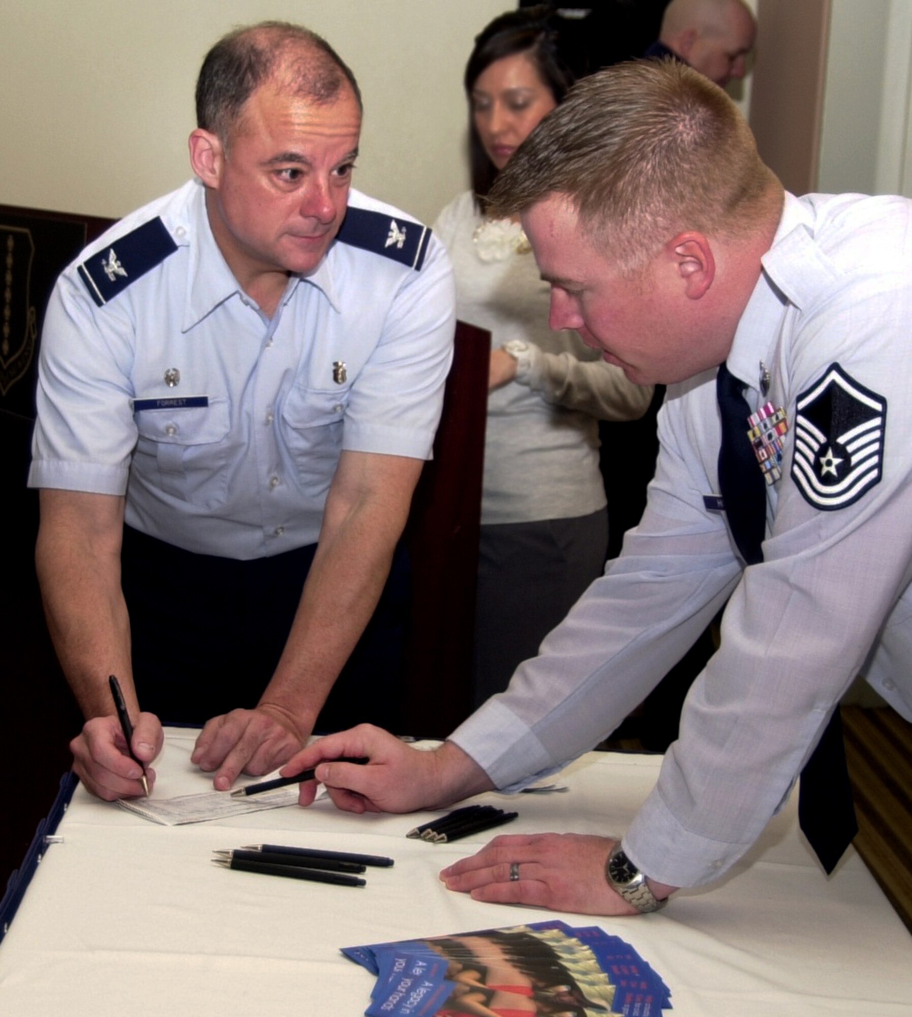 GOODFELLOW AIR FORCE BASE, Texas -- Col. James Forrest, 17th Medical Group Commander, speaks with Air Force Assistance Fund project officer, Master Sgt. Toby Hiseley, about  contributing to AFAF during the kickoff breakfast Feb. 14 at the Event Center.  (U.S. Air Force photo/Connie Hempel)