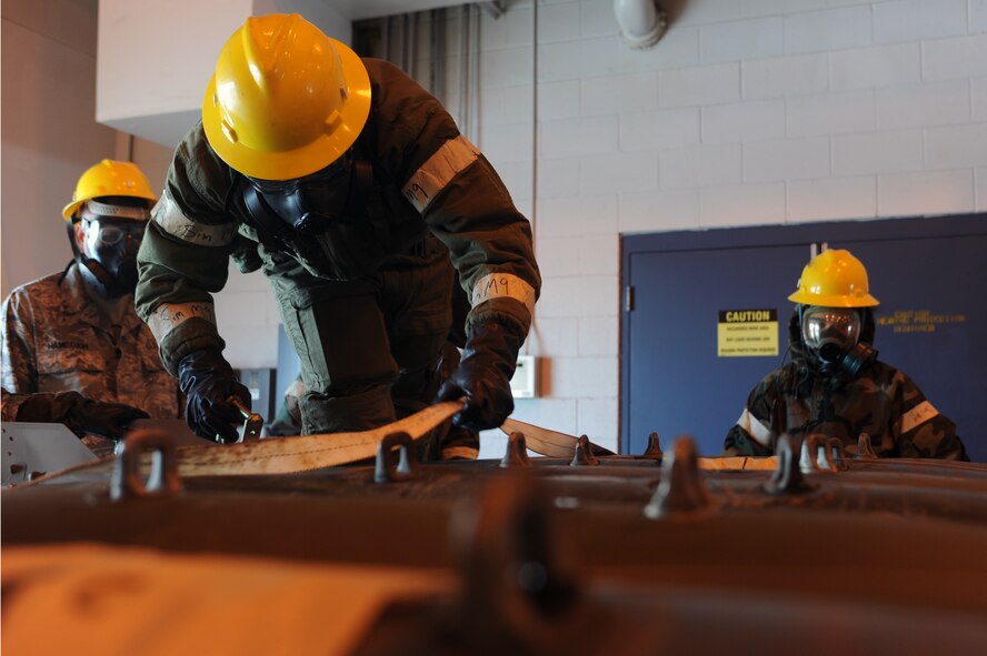 MINOT AIR FORCE BASE, N.D. -- Maintenance crew members from the 5th Munitions Squadron build six unguided bombs at the conventional maintenance shop during a base exercise here Feb. 11. Conventional maintenance crew members are evaluated while loading and assembling bombs to meet armor load standardizations to support the 23rd and 69th Bomb Squadrons. (U.S. Air Force photo/Airman 1st Class Aaron-Forrest Wainwright)