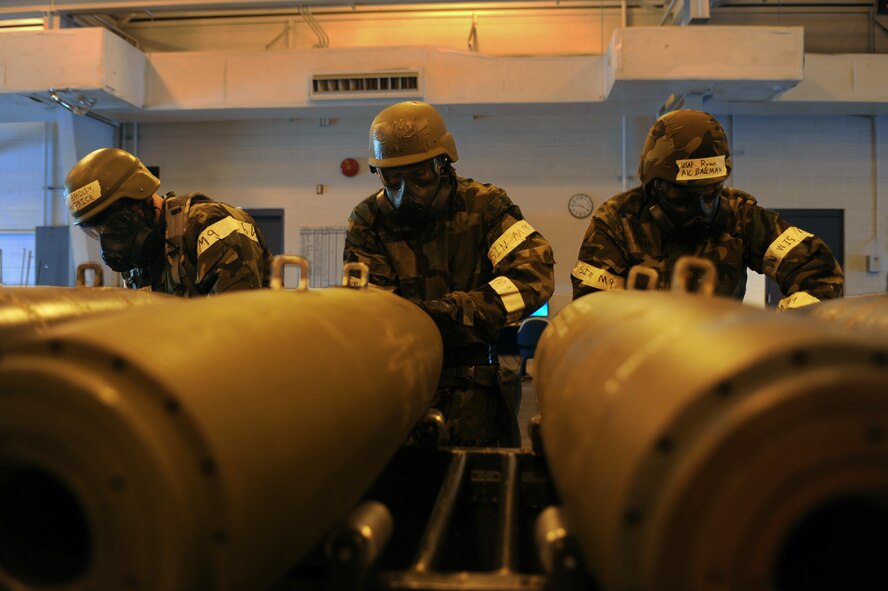 MINOT AIR FORCE BASE, N.D. -- Maintenance crew members from the 5th Munitions Squadron build six unguided bombs at the conventional maintenance shop during a base exercise here Feb. 11. Conventional maintenance crew members are evaluated while loading and assembling bombs to meet armor load standardizations to support the 23rd and 69th Bomb Squadrons. (U.S. Air Force photo/Airman 1st Class Aaron-Forrest Wainwright)