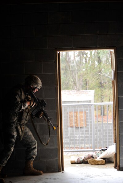 MOODY AIR FORCE BASE, Ga. -- Senior Airman James Leach, 822nd Base Defense Squadron fire team member, prepares to move out of the building with his three-man team after clearing the building of any opposing forces members Feb. 10. This was part of an exercise at the military operations in urban terrain training village which prepares members for what they may encounter during a deployment. (U.S. Air Force photo/Airman 1st Class Nicholas Benroth)(RELEASED)