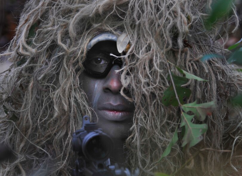 MOODY AIR FORCE BASE, Ga. -- Senior Airman Antwone Dunlap, 822nd Base Defense Squadron sniper team spotter, waits in preparation for the military operations in urban terrain training village demonstration to begin Feb.10. Airman Dunlap was part of a two-man sniper team that was set up outside the village to provide cover fire during the mission. (U.S. Air Force photo/Airman 1st Class Nicholas Benroth)(RELEASED)