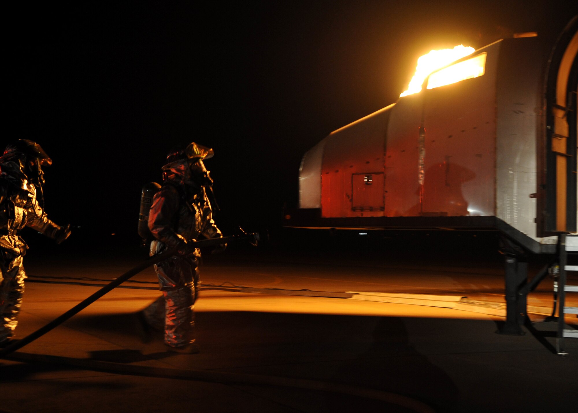 51st Fighter Wing firefighters respond to a simulated aircraft crash during Operational Readiness Exercise Beverly Midnight 11-01 at Osan Air Base, Republic of Korea Feb. 14.  The exercise allows Airmen to demonstrate their ability to complete the mission in simulated chemical environments while executing their primary duties, practicing self aid and buddy care, conduction post-attack reconnaissance and unexploded ordnance sweeps. (U.S. Air Force Photo/Senior Airman Evelyn Chavez)