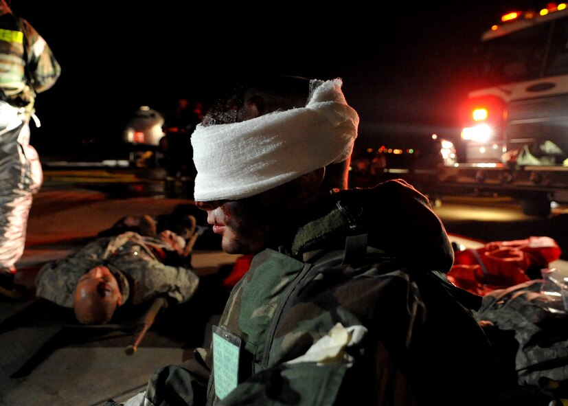 A "casualty" waits to be treated after a simulated aircraft crash during Operational Readiness Exercise Beverly Midnight 11-01 at Osan Air Base, Republic of Korea Feb. 14.  The exercise allows Airmen to demonstrate their ability to complete the mission in simulated chemical environments while executing their primary duties, practicing self aid and buddy care, conduction post-attack reconnaissance and unexploded ordnance sweeps. (U.S. Air Force Photo/Senior Airman Evelyn Chavez)