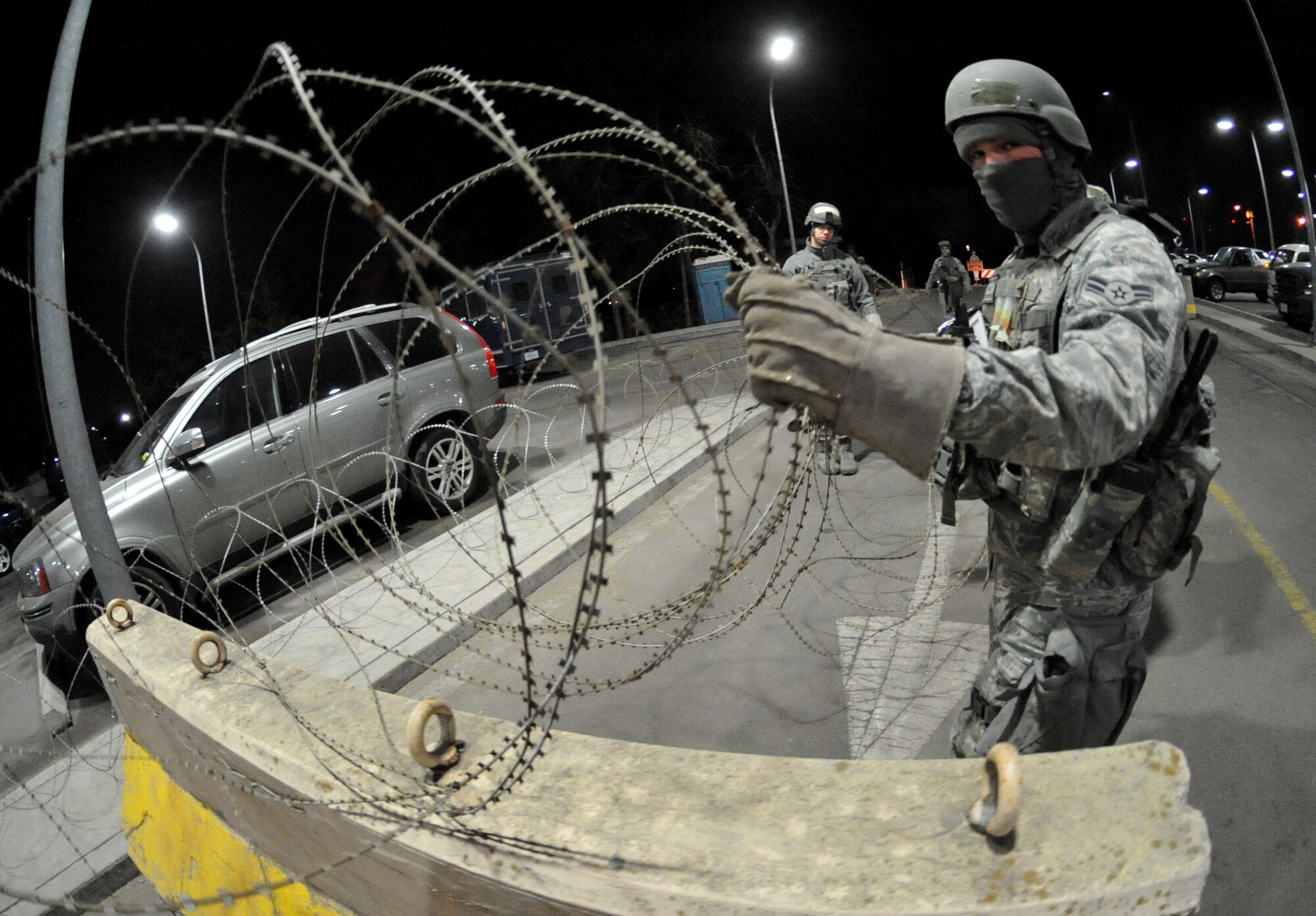 A 51st Fighter Wing Security Forces Airman secures a building during Operational Readiness Exercise Beverly Midnight 11-01 at Osan Air Base, Republic of Korea Feb. 14.  The exercise allows Airmen to demonstrate their ability to complete the mission in simulated chemical environments while executing their primary duties, practicing self aid and buddy care, conduction post-attack reconnaissance and unexploded ordnance sweeps. (U.S. Air Force Photo/Senior Airman Evelyn Chavez)