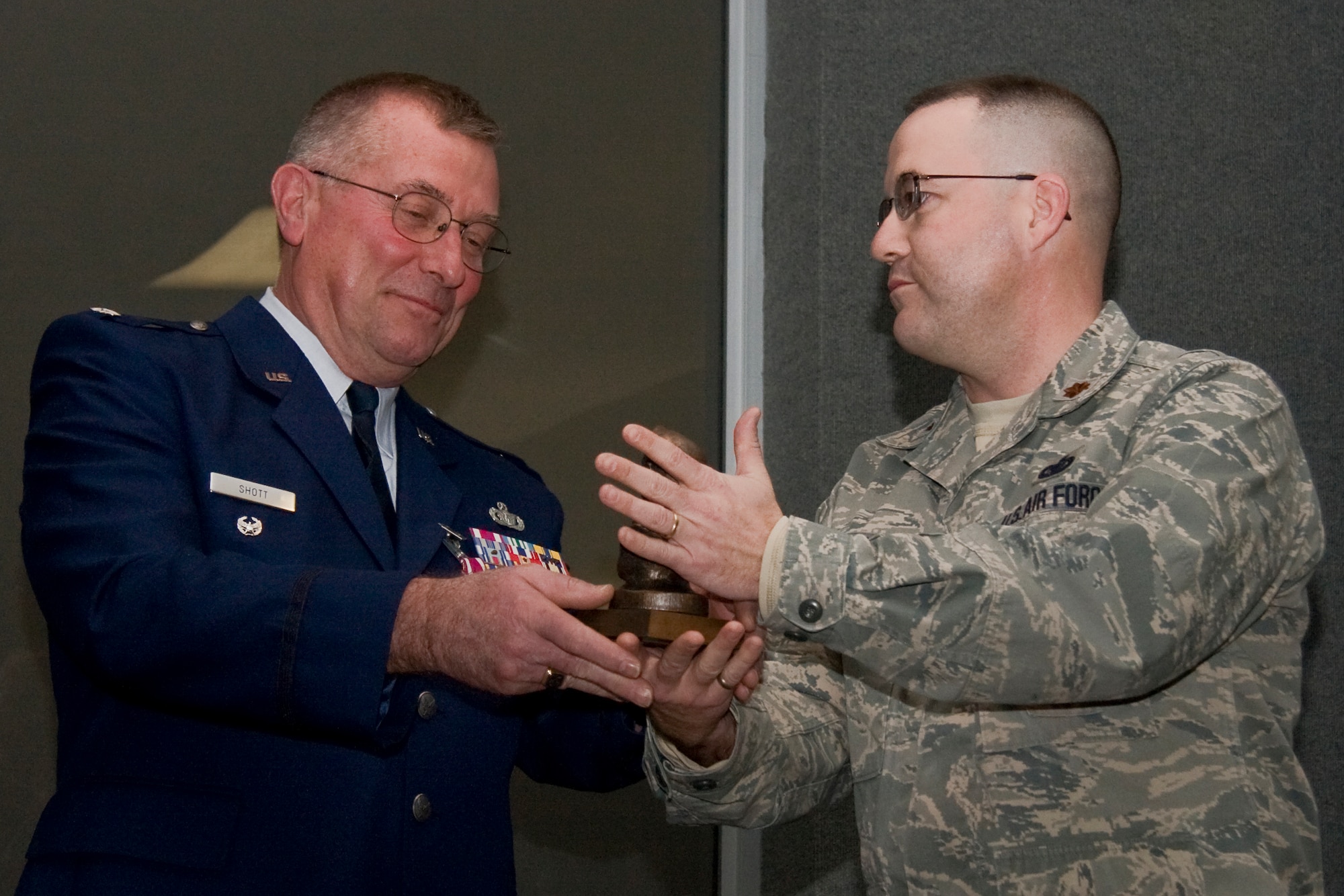 GRISSOM AIR RESERVE BASE, Ind. -- Maj. Christopher Witter, 434th Security Forces Squadron commander, presents Lt. Col. Phil Shott with a statue of a security forces Airmen during the colonel?s retirement ceremony here recently. Colonel Shott was a security Forces Airman who had previously served as the 434th SFS commander. (U.S. Air Force photo/Tech. Sgt. Mark R. W. Orders-Woempner)
