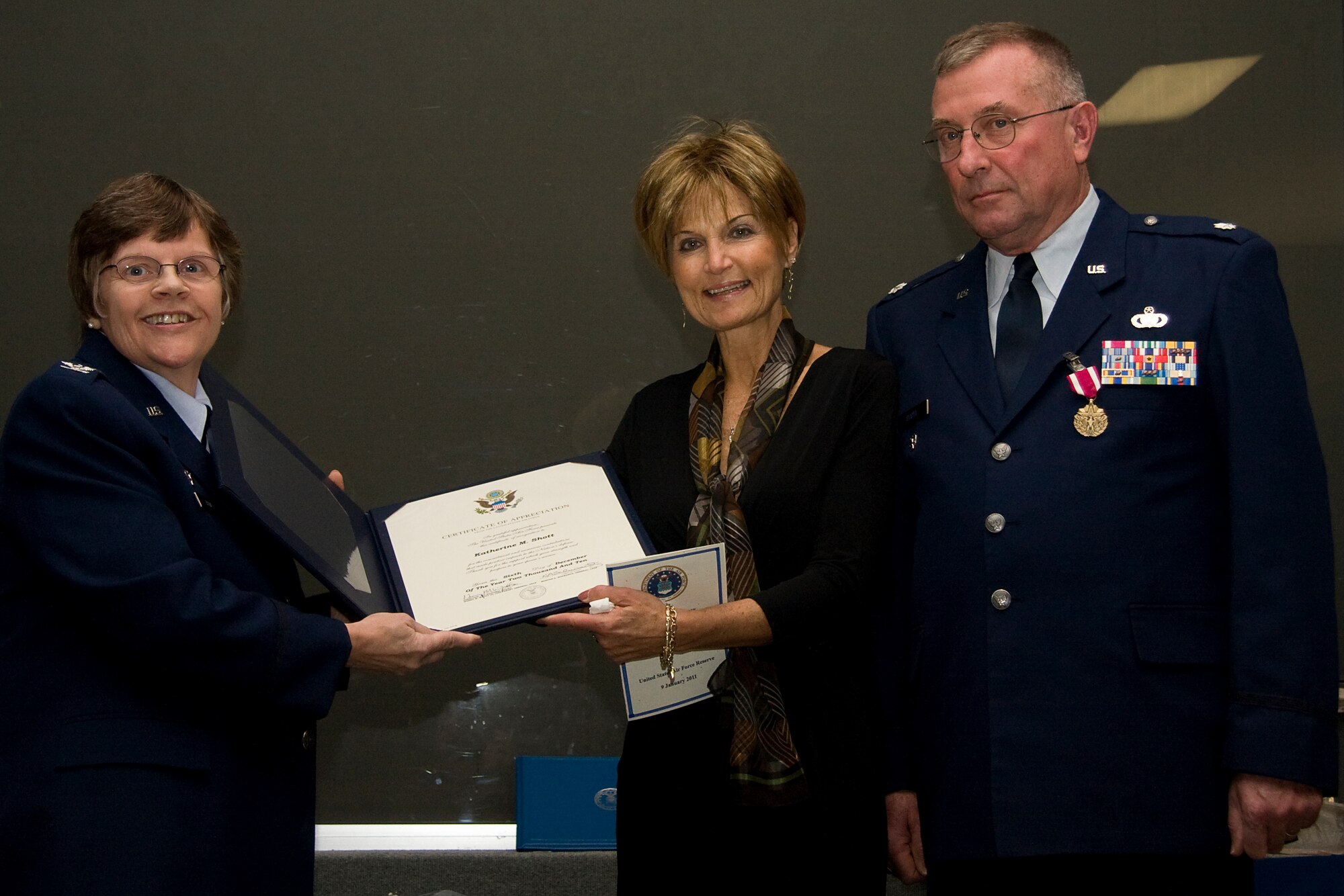 GRISSOM AIR RESERVE BASE, Ind. -- Col. Betty Bowen, 434th Mission Support Group commander, presents Katherine Shott with a certificate of appreciation as her husband, Lt. Col. Phil Shott, watches on. Mrs. Shott was presented the memento as thanks to her many years of dedicated support to Colonel Shott during his retirement ceremony here recently. (U.S. Air Force photo/Tech. Sgt. Mark R. W. Orders-Woempner)
