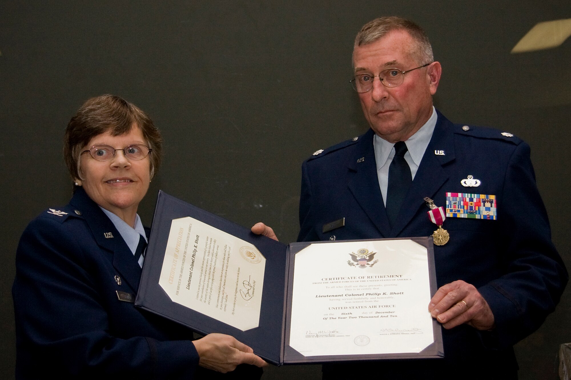 GRISSOM AIR RESERVE BASE, Ind. -- Col. Betty Bowen presents Lt. Col. Phil Shott with his certificate of retirement during a special ceremony held here recently. Colonel Shott retired as the 434th Mission Support Group deputy commander, and Colonel Bowen, the 434th MSG commander, presided over the event.  (U.S. Air Force photo/Tech. Sgt. Mark R. W. Orders-Woempner)
