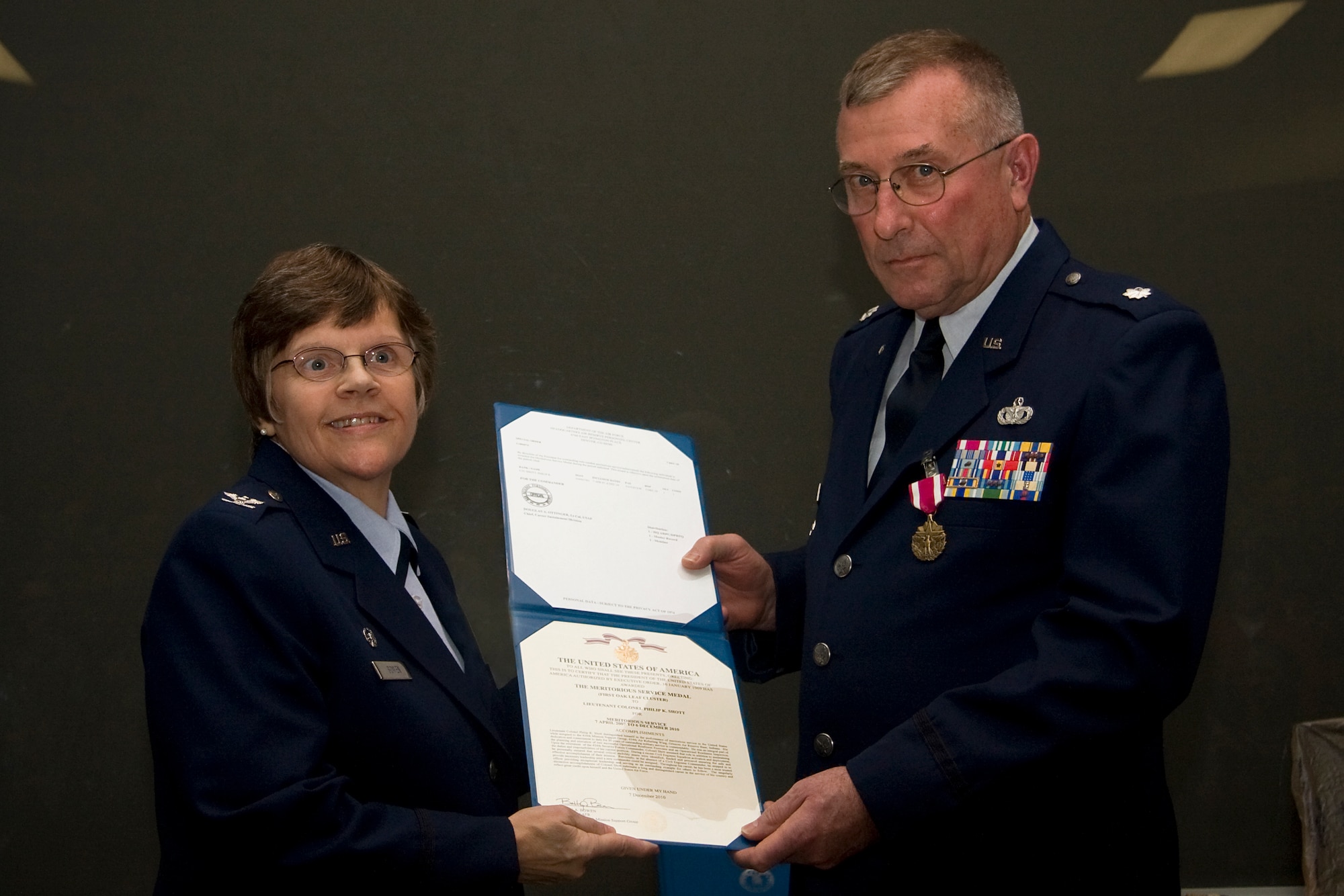 GRISSOM AIR RESERVE BASE, Ind. -- Lt. Col. Phil Shott poses for a photo with Col. Betty Bowen after receiving a meritorious service medal during his retirement ceremony held here recently. Colonel Shott retired as the 434th Mission Support Group deputy commander, and Colonel Bowen is the 434th MSG commander. (U.S. Air Force photo/Tech. Sgt. Mark R. W. Orders-Woempner)
