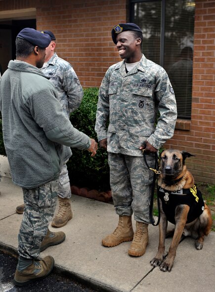 MOODY AIR FORCE BASE, Ga. -- Staff Sgt. Ronald Young, 23rd Security Forces Squadron military working dog handler, laughs with Brig. Gen. Jimmy McMillian, security forces director at Headquarters U.S. Air Force, during his visit Feb. 10. One of the general’s stops was at the 23rd SFS MWD handler’s facility where he spoke with the handlers and received a tour of their facility. (U.S. Air Force photo/Airman 1st Class Nicholas Benroth)(RELEASED)