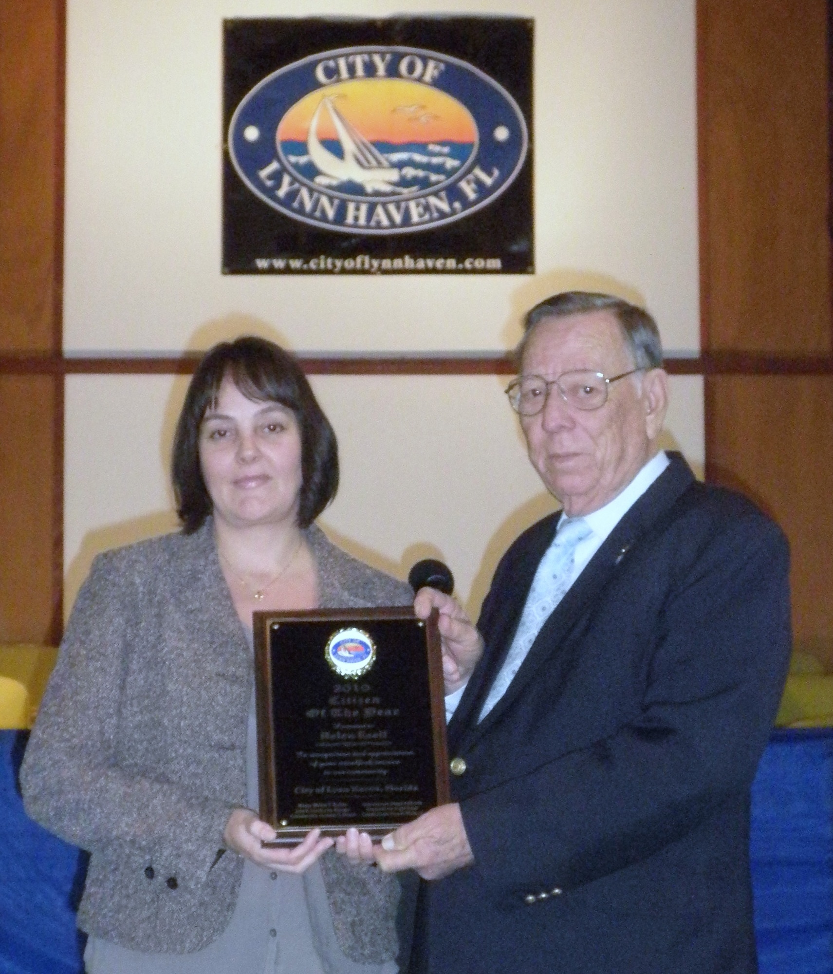 Lynn Haven, Fla., Mayor Walter T. Kelley presents Helen Ezell with a plaque commemorating her selection as the city’s Citizen of the Year. Mrs. Ezell is the founder and director of the Autism Education Center in Lynn Haven. (Courtesy photo)