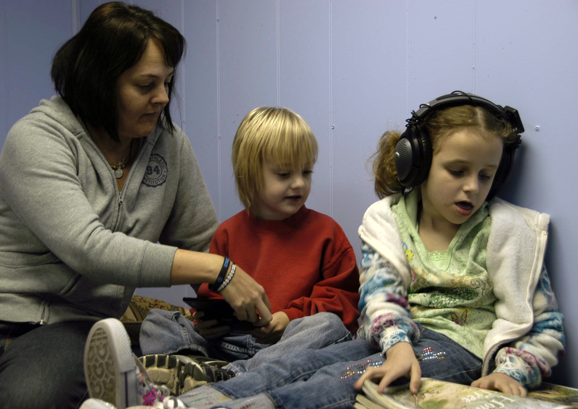 Helen Ezell, founder and director of the Autism Education Center in Lynn Haven, Fla., conducts therapeutic listening with 6-year-old Mandela Carson at the center while her 5-year-old son Riley Ezell watches. Because of her efforts with the AEC and within the community, Mrs. Ezell was named Lynn Haven’s Citizen of the Year. (U.S. Air Force photo/Angela Pope)