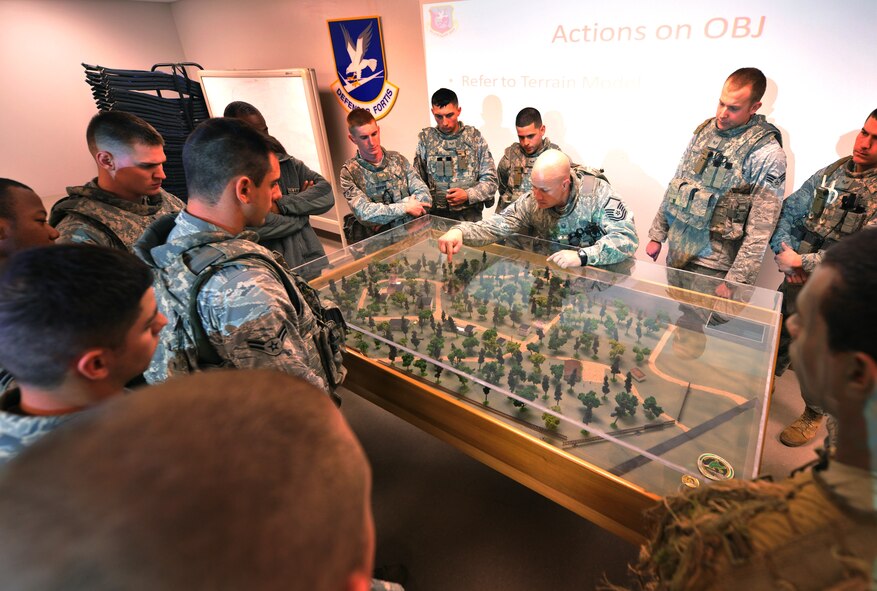 MOODY AIR FORCE BASE, Ga.-- Airmen from the 822nd Base Defense Squadron gather around a layout of military operations in urban terrain village training facility during a base visit from Brig. Gen. Jimmy McMillian, Headquarters Air Force director of security forces, Feb. 10. The 822nd BDS Airmen gave General McMillan a first-hand look into the type of training they perform on a daily basis. (U.S. Air Force photo/Airman 1st Class Joshua Green)(RELEASED)
