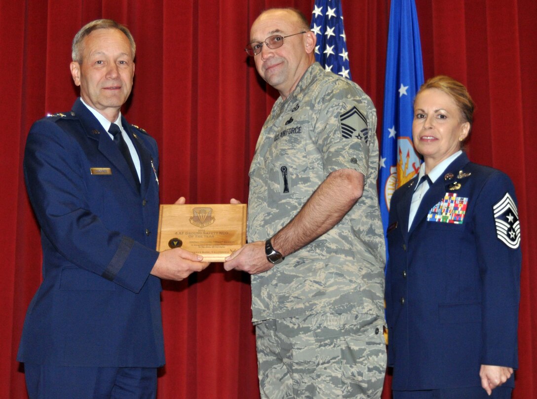 Maj. Gen. Eric W. Crabtree, commander, Fourth Air Force, March Air Reserve Base, Calif., presents a plaque to Senior Master Sgt. Michael Eckert during the Fourth Air Force commander's call, February 13, 2011. Sergeant Eckert was recognized for being selected as Fourth Air Force Ground Safety NCO of the year.