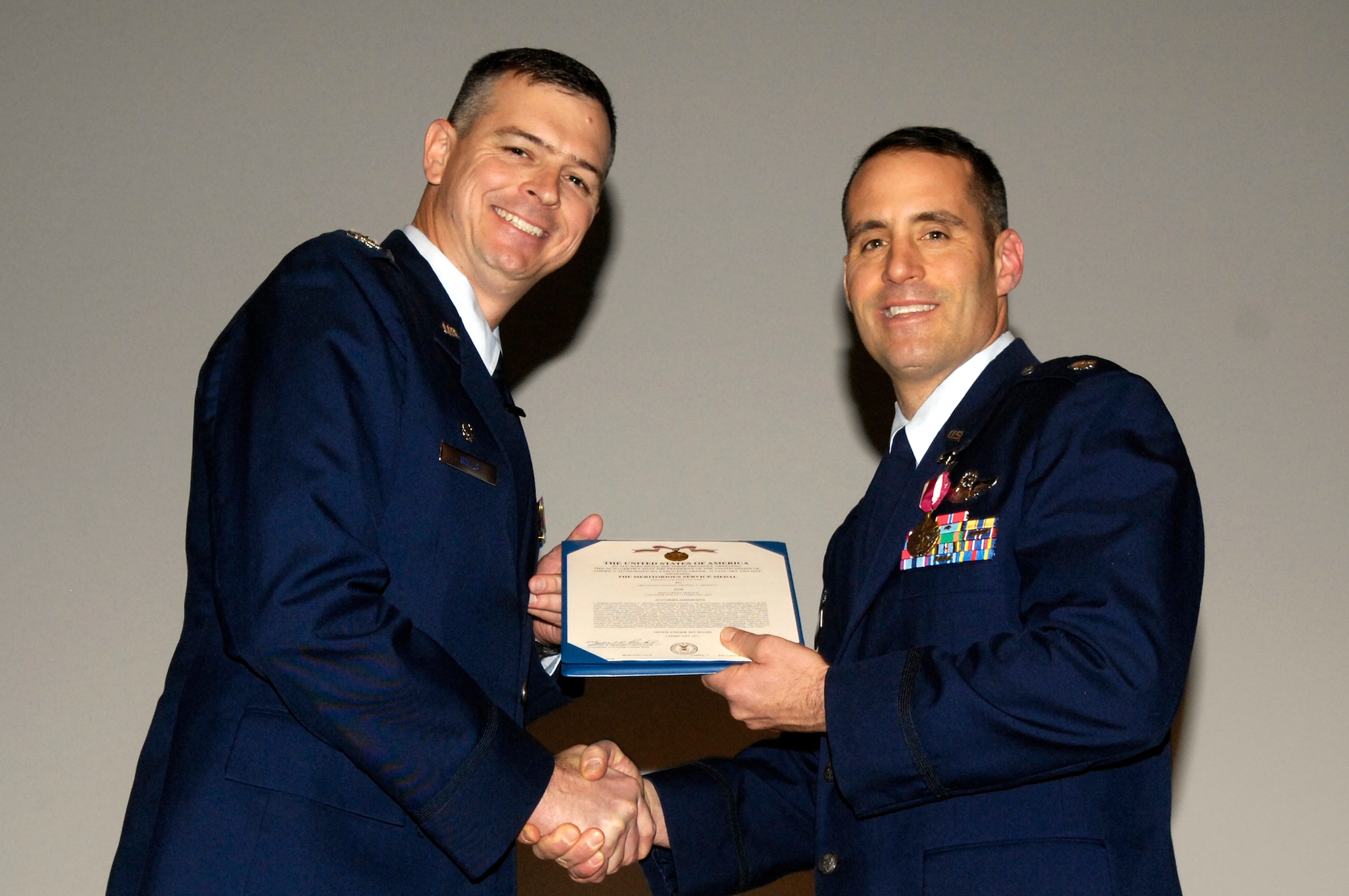 LAUGHLIN AIR FORCE BASE, Texas – Col. Craig Wills, 47th Operations Group commander, congratulates Lt. Col. Michael Brockey, the new 47th OG deputy commander, on achieving a Meritorious Service Medal for his service as the 47th Operations Support Squadron commander. Lieutenant Col. Brockey’s command was assumed by Lt. Col. John Binder, 47th OSS commander, Feb. 11. (U.S. Air Force photo by Jose Mendoza)