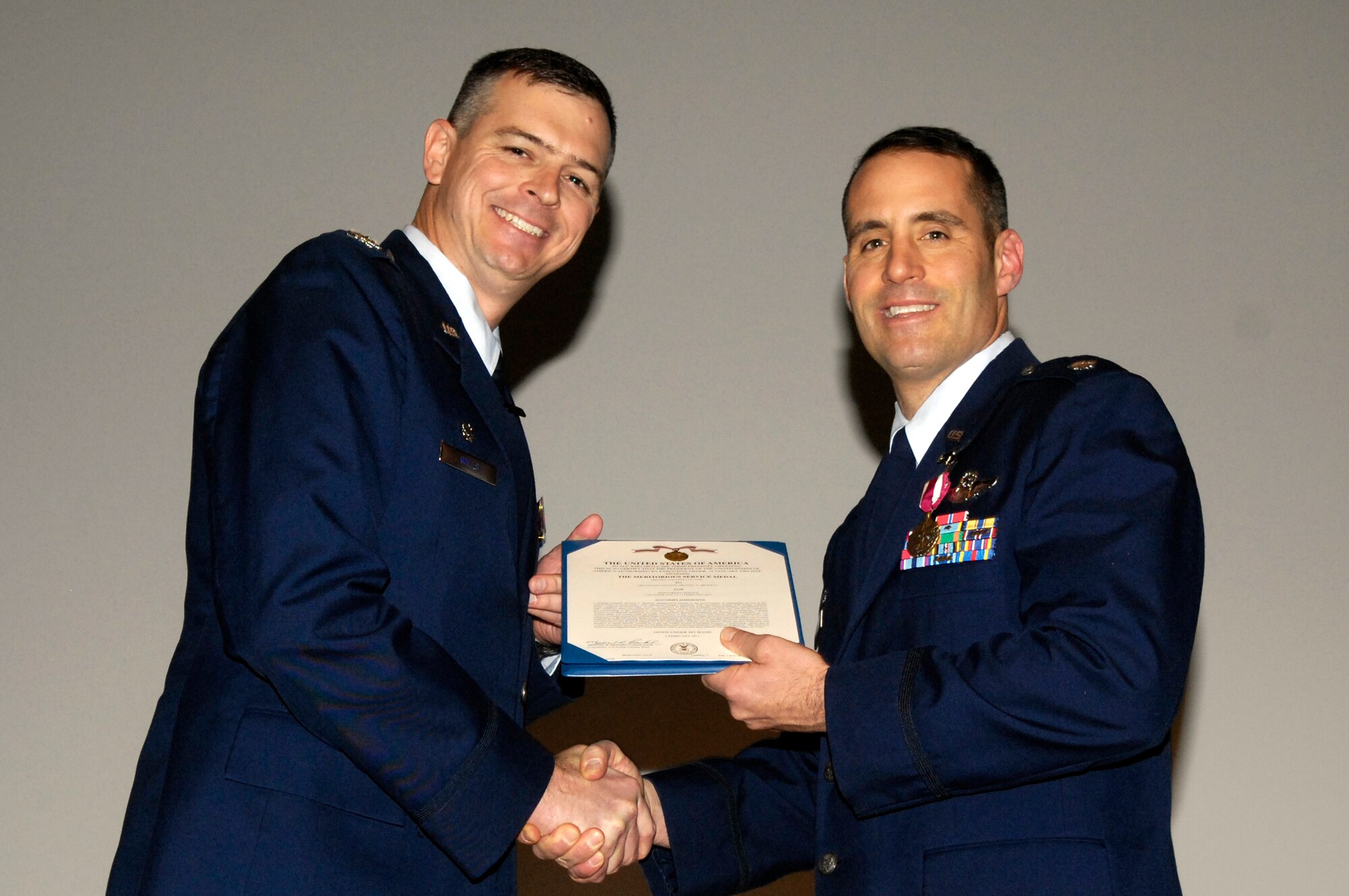 LAUGHLIN AIR FORCE BASE, Texas – Col. Craig Wills, 47th Operations Group commander, congratulates Lt. Col. Michael Brockey, the new 47th OG deputy commander, on achieving a Meritorious Service Medal for his service as the 47th Operations Support Squadron commander. Lieutenant Col. Brockey’s command was assumed by Lt. Col. John Binder, 47th OSS commander, Feb. 11. (U.S. Air Force photo by Jose Mendoza)