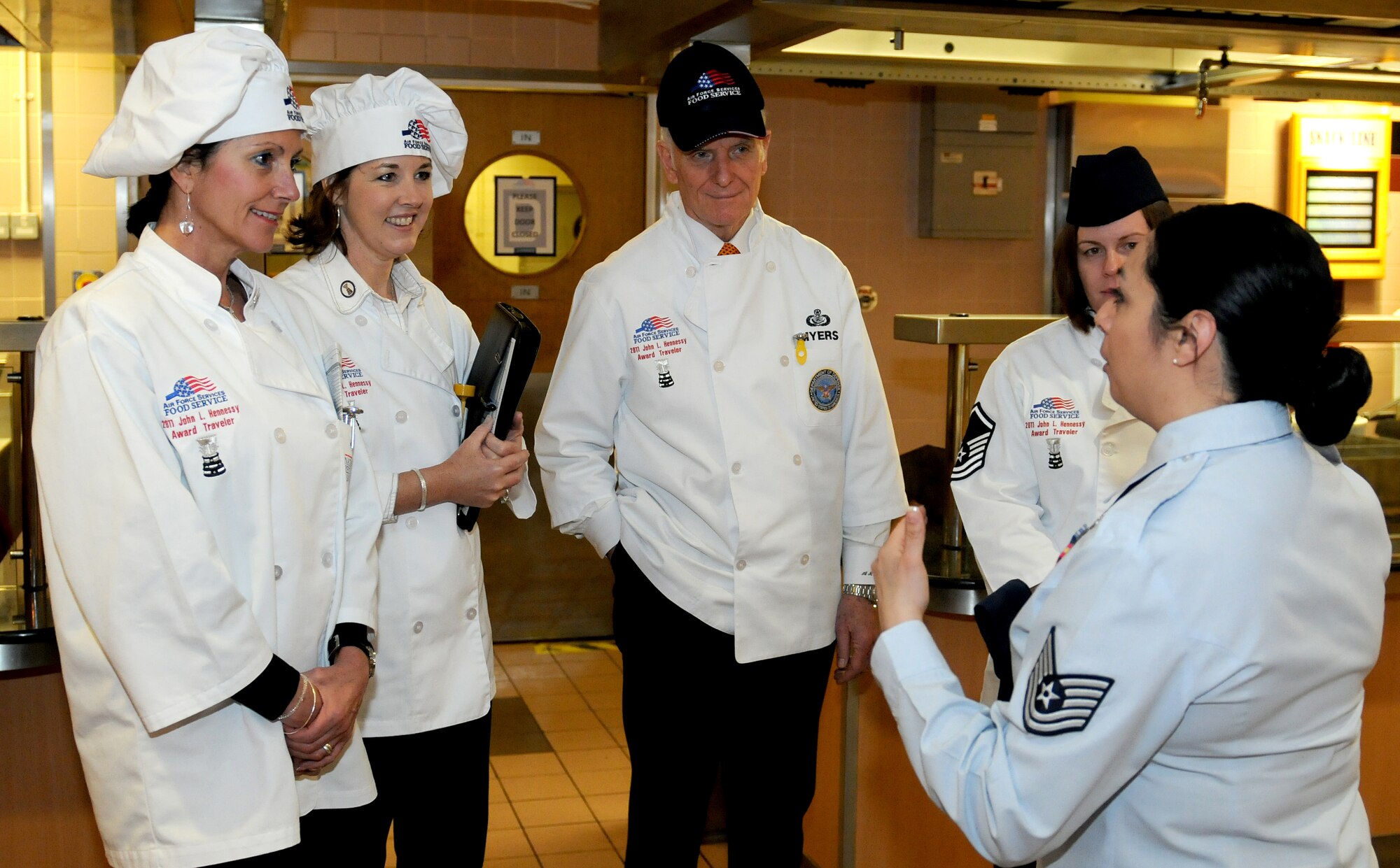 RAF MILDENHALL, England -- Tech. Sgt. Angela Frazier, 100th Force Support Squadron assistant NCO in charge of the Gateway Dinning Facility (right), gives a tour of the facility to the Hennessy Award evaluation team here Feb. 14, 2011.  The team will be evaluating the Gateway and Hardstand Dining Facilities Feb. 14 and 15 for the Hennessy Award, the oldest military food service award. (U.S. Air Force photo/Senior Airman Tabitha Lee)  