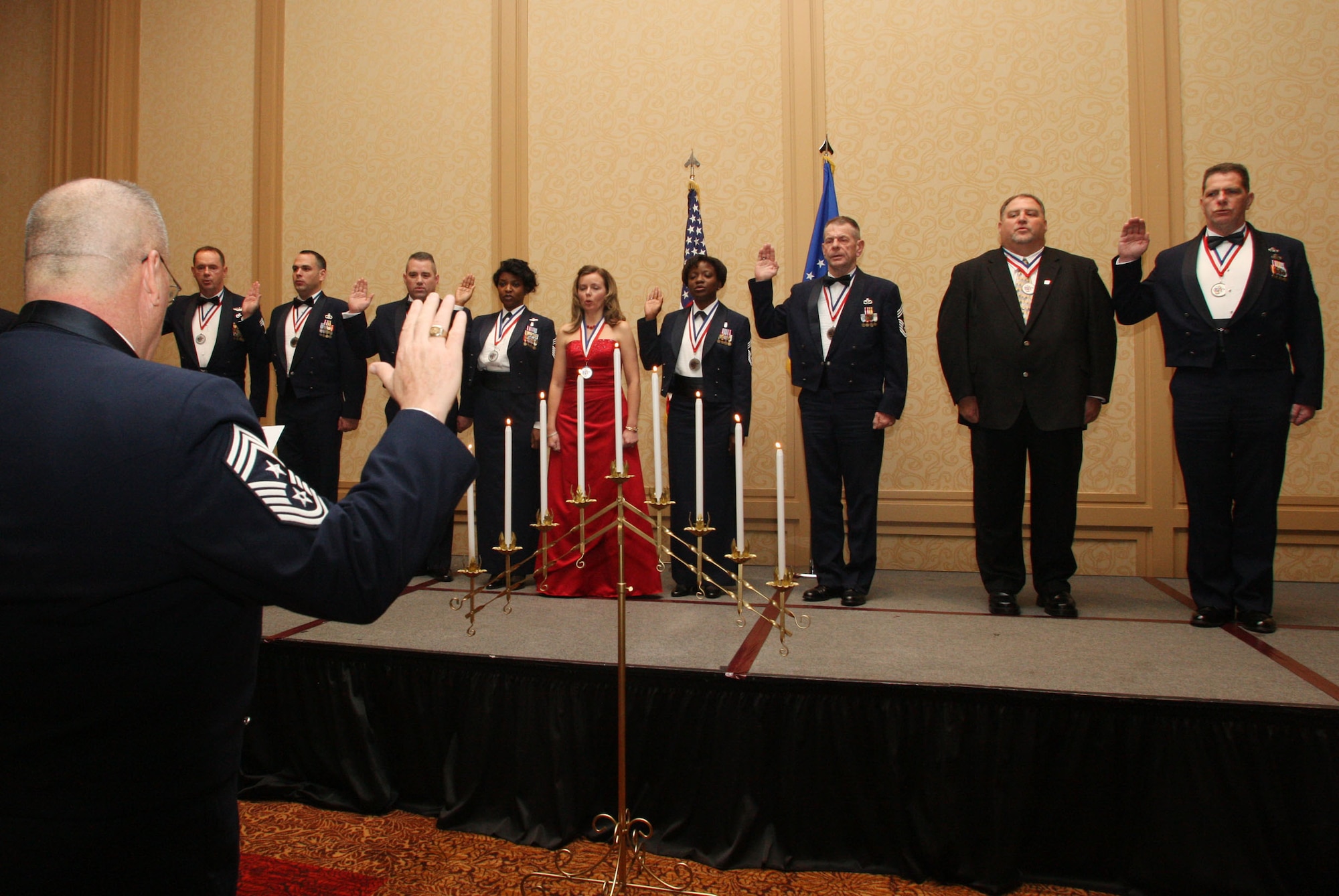 Chief Master Sgt. John Anderson, 94th Airlift Wing Command Chief swears in the honorees Feb 5. (U.S. Air Force Photo/Don Peek)