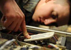 Senior Airman Amos Hommel discharges a high voltage capacitor on a GRT-22 radio amplifier  at the transmissions systems office Feb. 11, 2011 on Joint Base Charleston, S.C. The amplifier boosts the ground to air radio's power from t10 watts to 50 watts allowing it to contact aircraft from a much greater distance. Airman Hommel is a Radio Frequency Transmissions Systems Technician with the 628th Communications Squadron. (U.S. Air Force photo/Senior Airman Timothy Taylor)