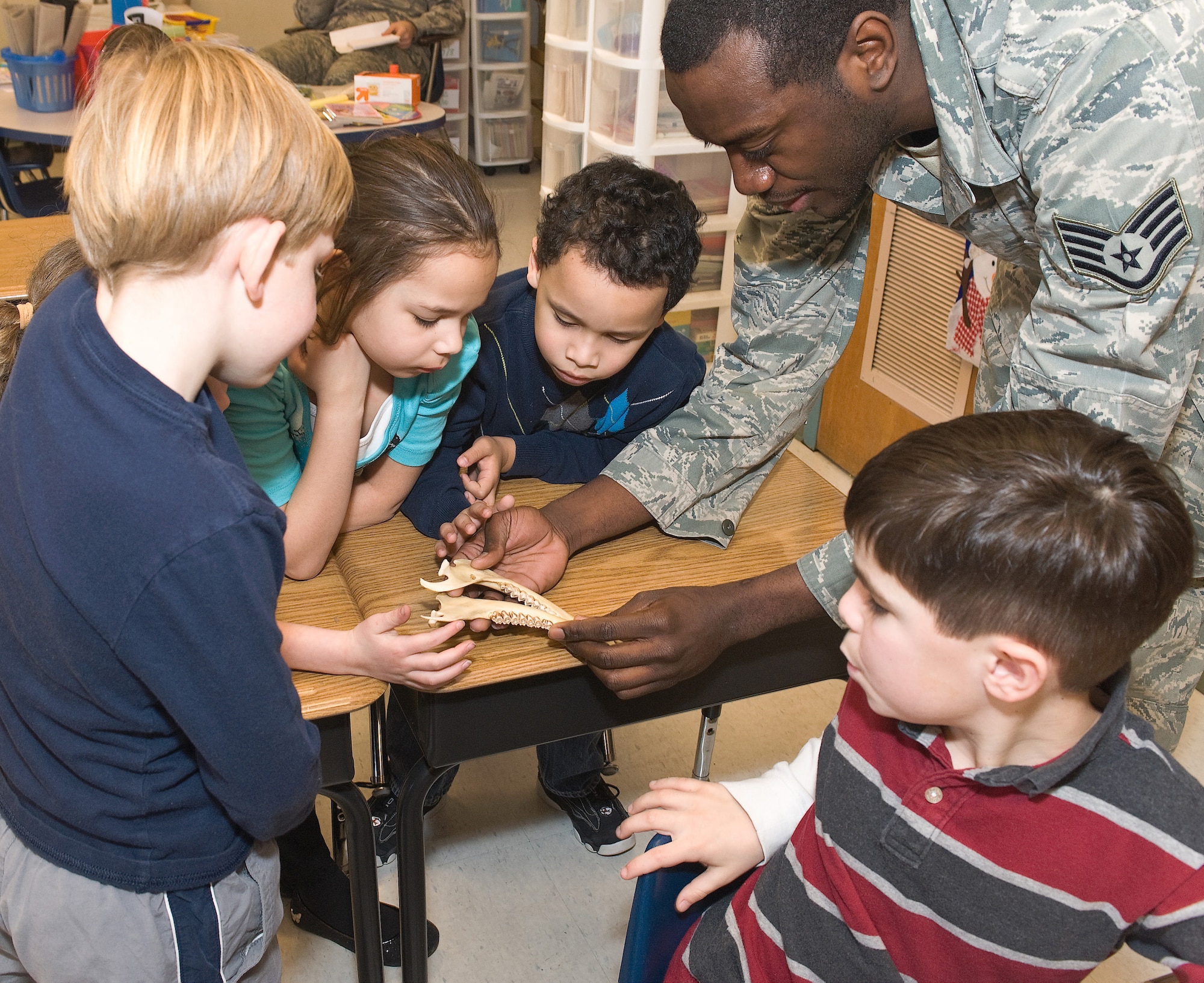 Staff Sgt. James Brown,  436th Dental Squadron noncommissioned officer in charge of preventative dentistry, shows healthy and unhealthy teeth to students in Sue Taraila?s 1st  grade class Feb. 10, 2011, at Maj. George S. Welch Elementary School at Dover AFB, Del. (U.S. Air Force photo/Roland Balik) 