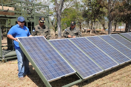 SOTO CANO AIR BASE, Honduras -- Joint Task Force-Bravo, the Honduran military and the Comisión Permanente de Contingencias, trained and exercised on equipment together here Feb. 2 through 10, on equipment that can enable them to provide aid following disasters. Here Honduran military representatives National Defense University assistance, set up the solar panels that produces hybrid power.  The panels are a portion of the Prepositioned Exercise Assistance Kit. JTF-Bravo is committed to full partnerships with Central American governments in training and missions to support security, stability and prosperity throughout the region. (U.S. Air Force photo/Staff Sgt. Kimberly Rae Moore)