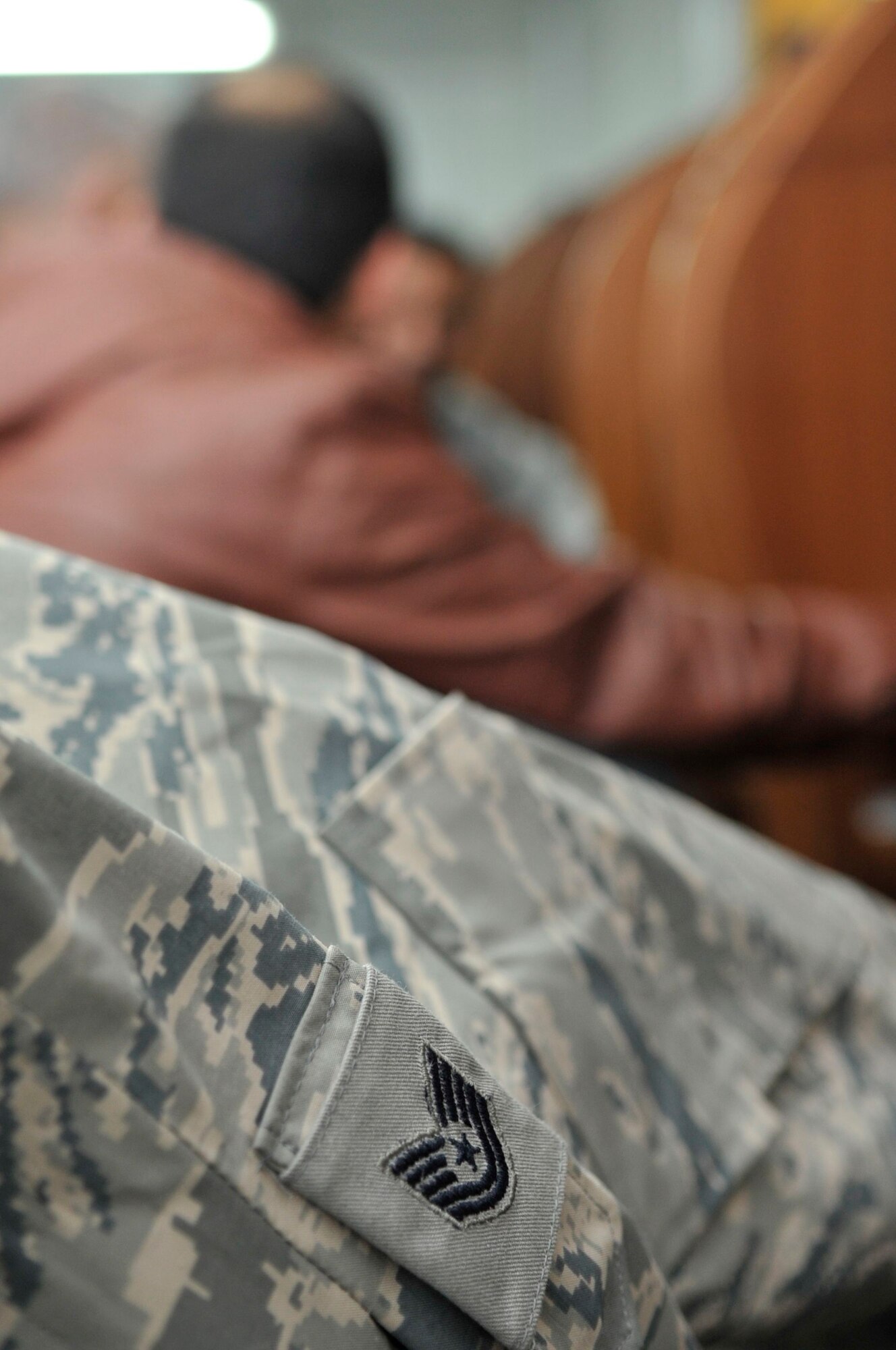 BAGHDAD, Iraq – A U.S. Air Force chevron for a technical sergeant is visible on a uniform jacket of U.S. Air Force Tech. Sgt. Fatema Tahan, Iraq Security Assistance Mission English Language Program test administrator,  inside the English Language Program testing trailer at Forward Operating Base Union III, International Zone, here Feb. 6. (U.S. Air Force photo by Senior Master Sgt. Larry Schneck/Released)